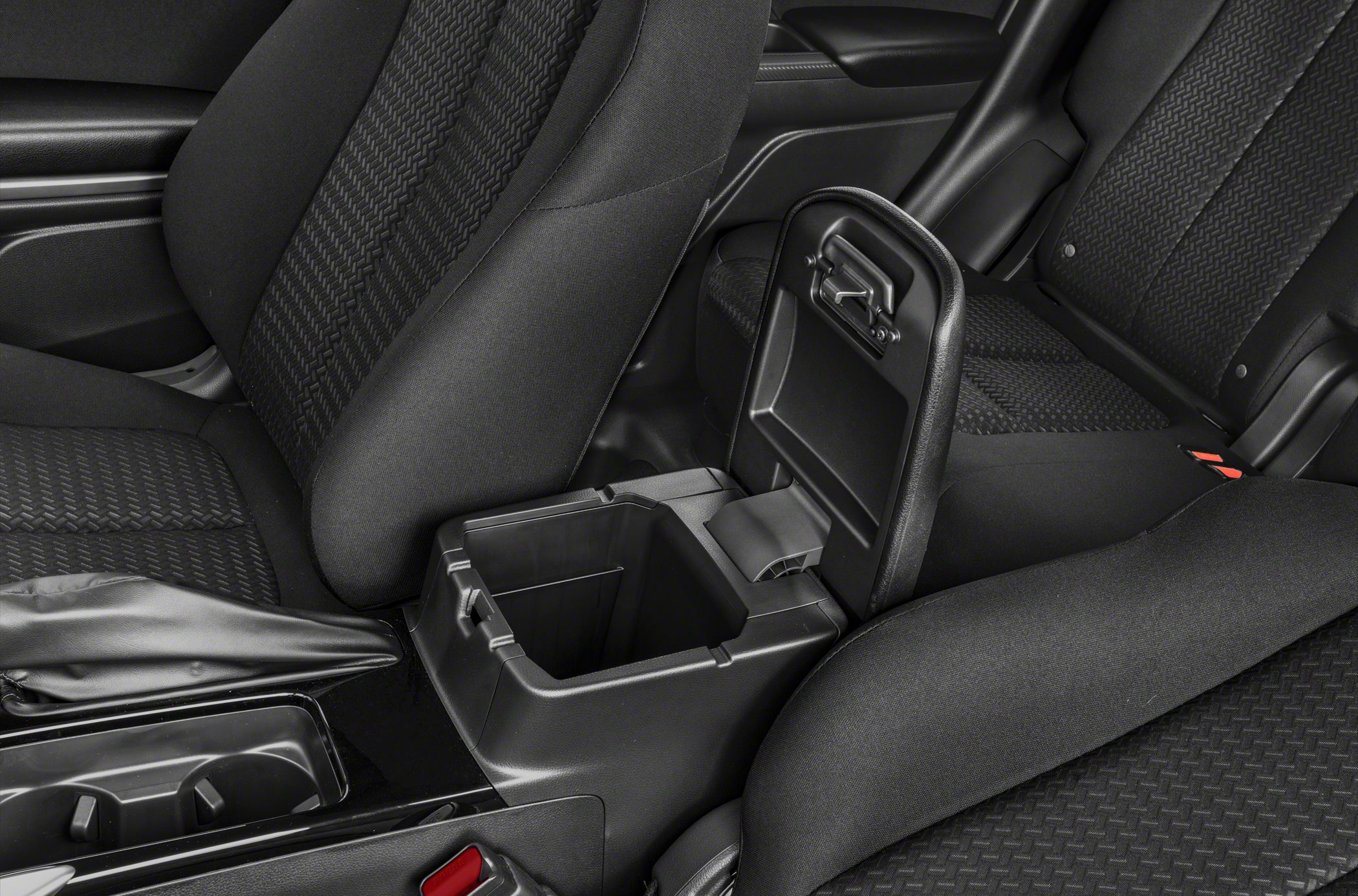 Interior center console storage compartment opened between front seats