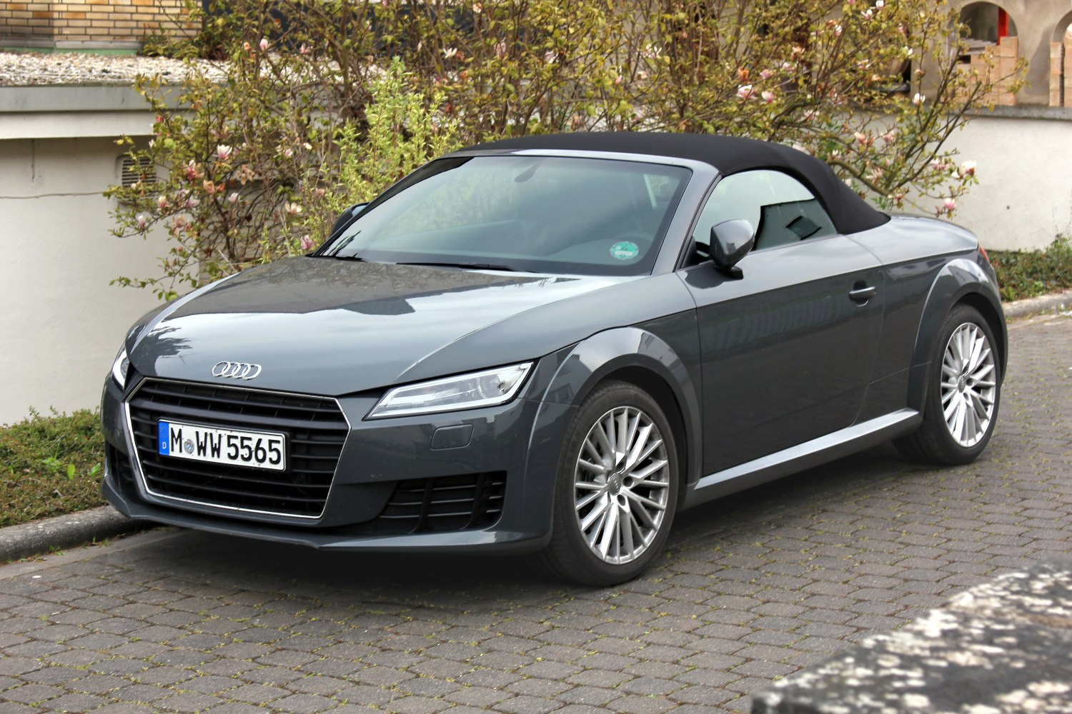 Front side view of convertible with soft top and alloy wheels