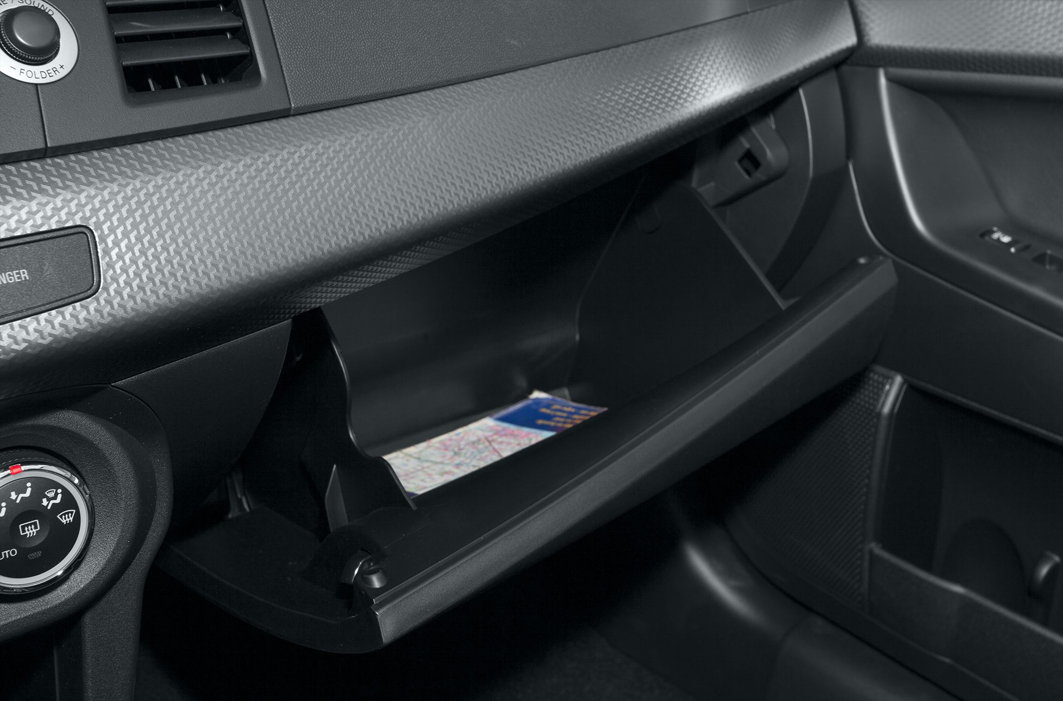 Open glove box with textured dashboard interior