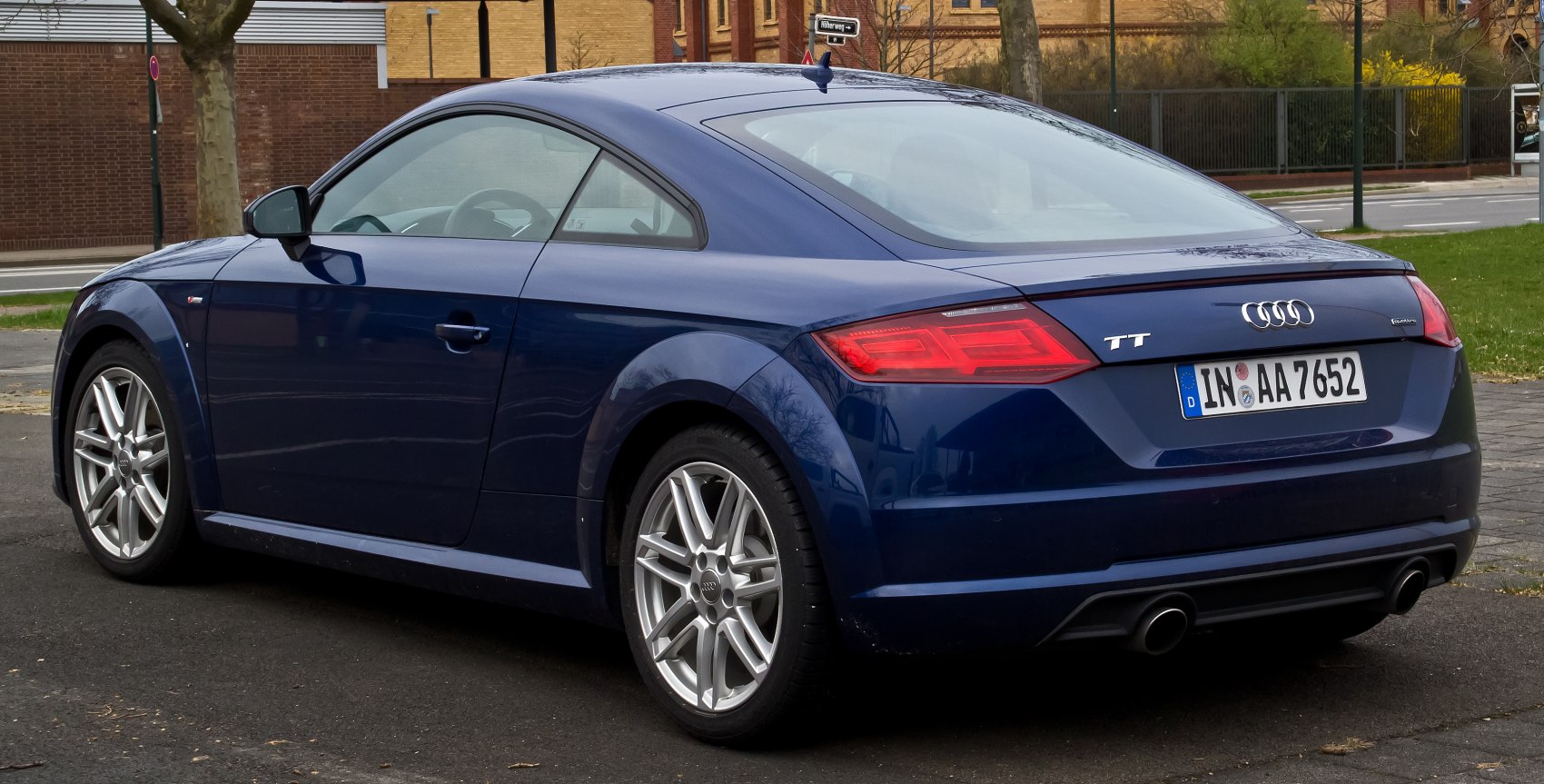 Rear side view with sleek taillights and alloy wheels.