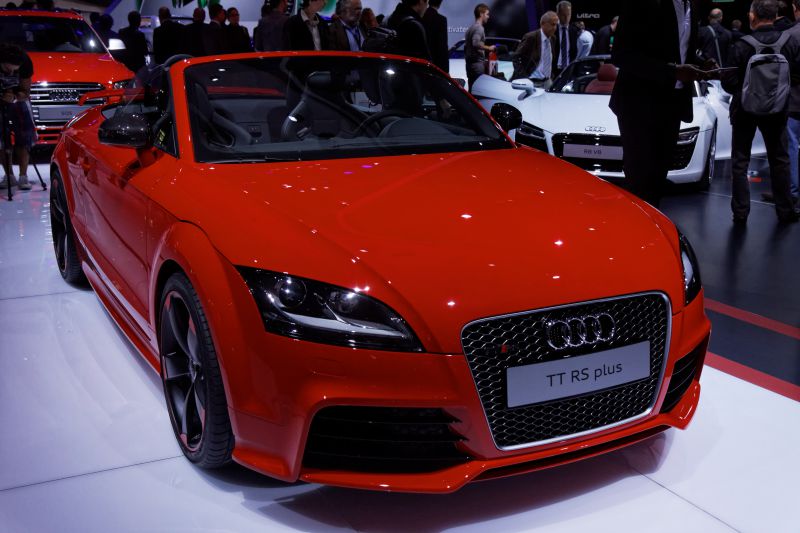 Red sports convertible with aggressive front grille and sleek headlights