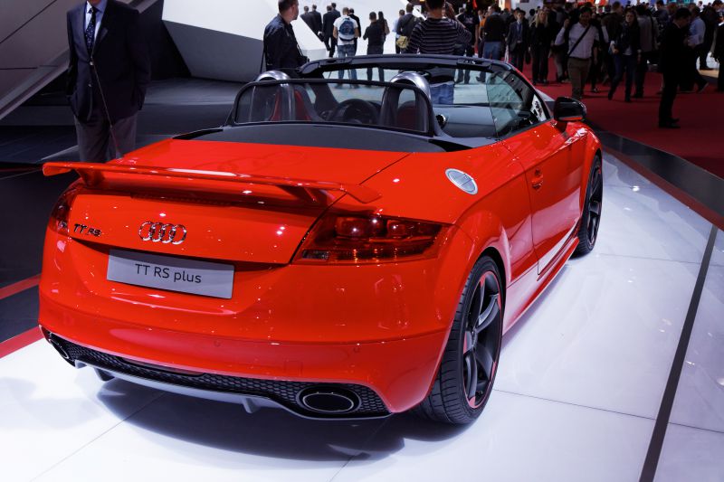 Rear view of red convertible with spoiler and dual exhausts