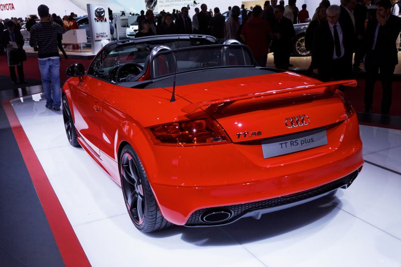 Red convertible with rear spoiler and dual exhausts