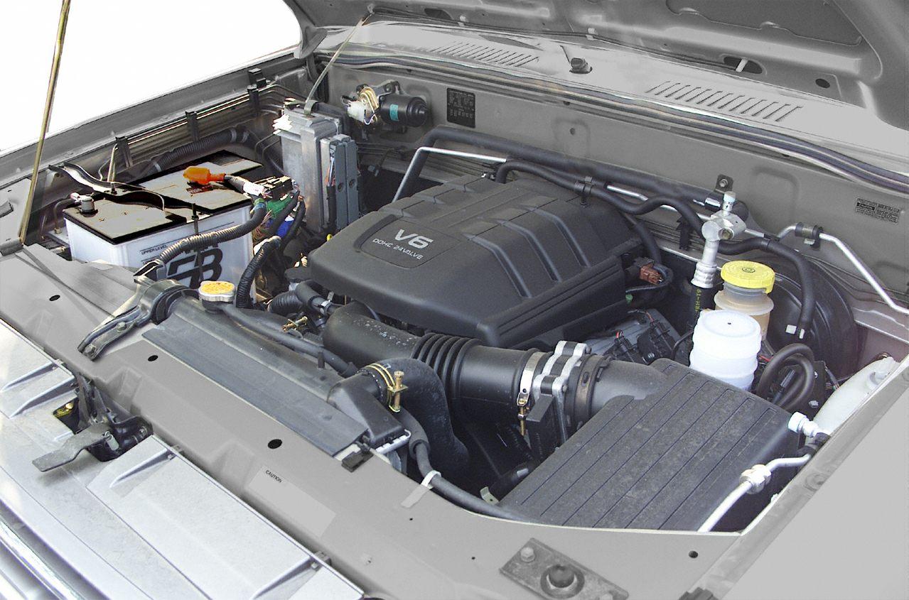 V6 engine bay with air intake, battery, and fluid reservoirs