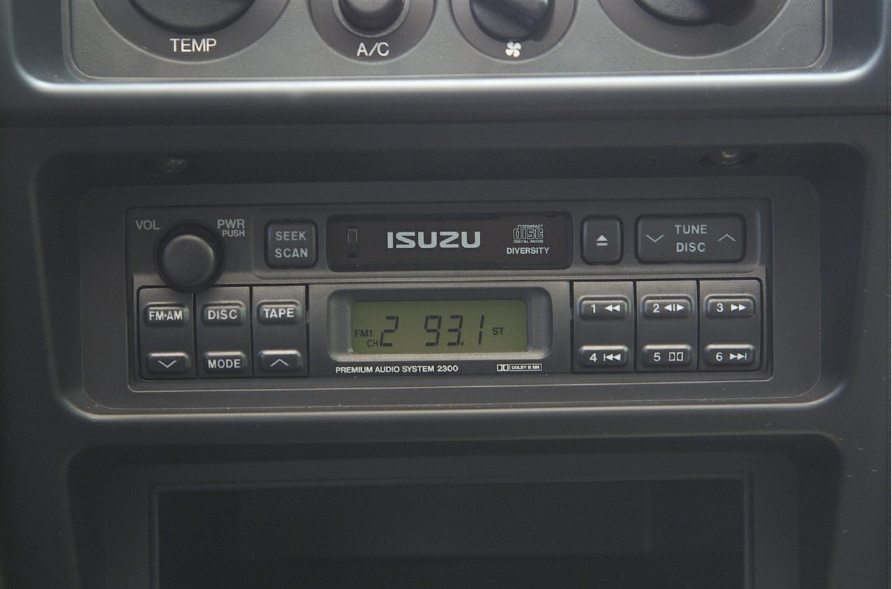 Vintage car radio with tape, CD player, preset buttons and digital frequency display