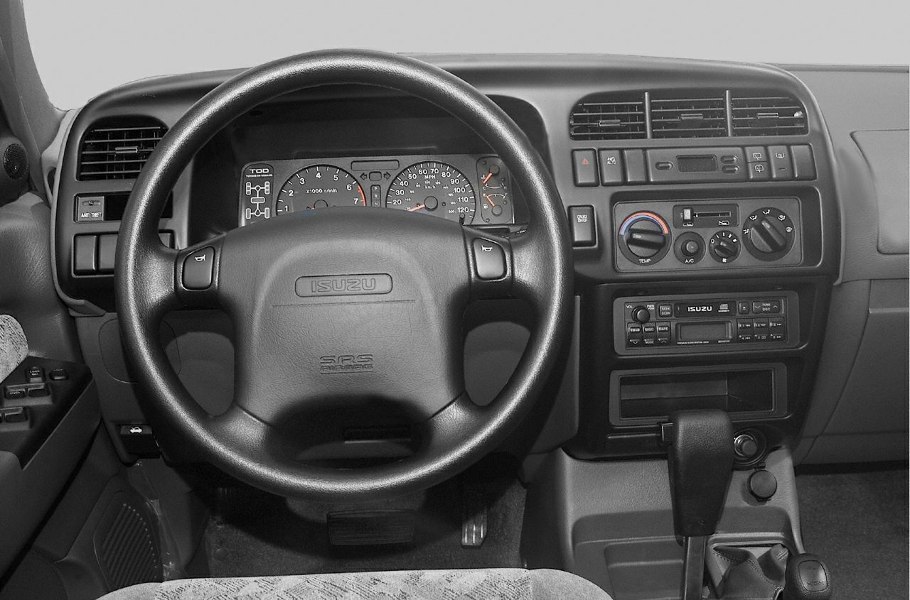 1998 SUV dashboard and steering wheel with analog gauges and manual controls