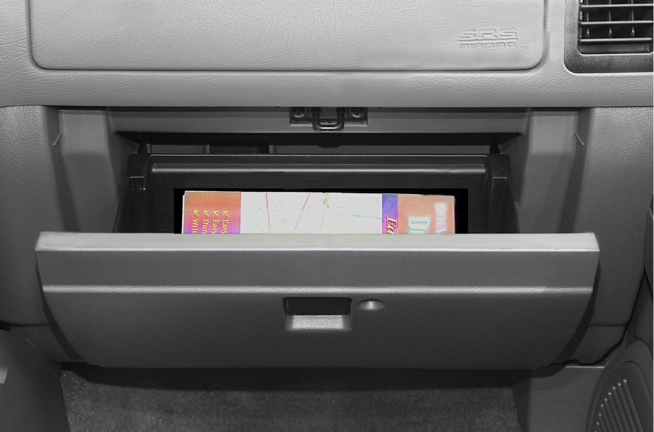 Open glove compartment with visible storage and latch