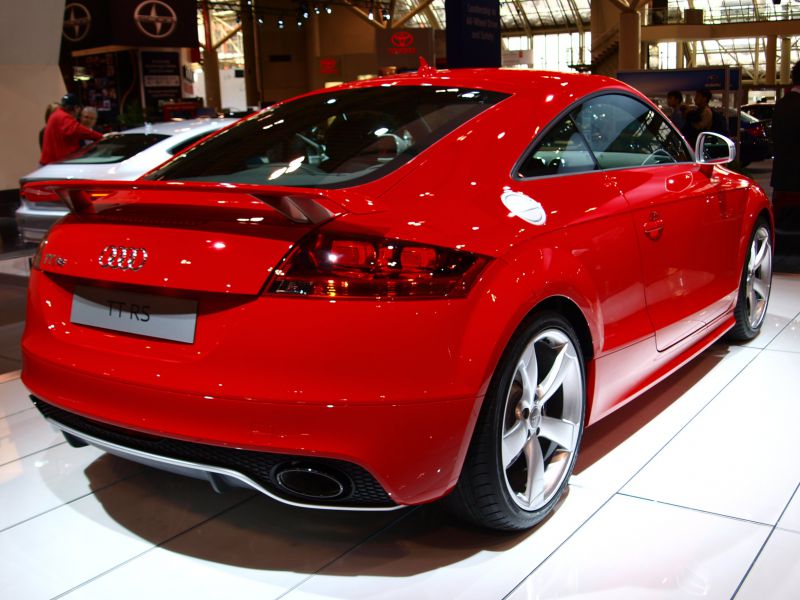 Rear view of red sports coupe with spoiler and modern taillights
