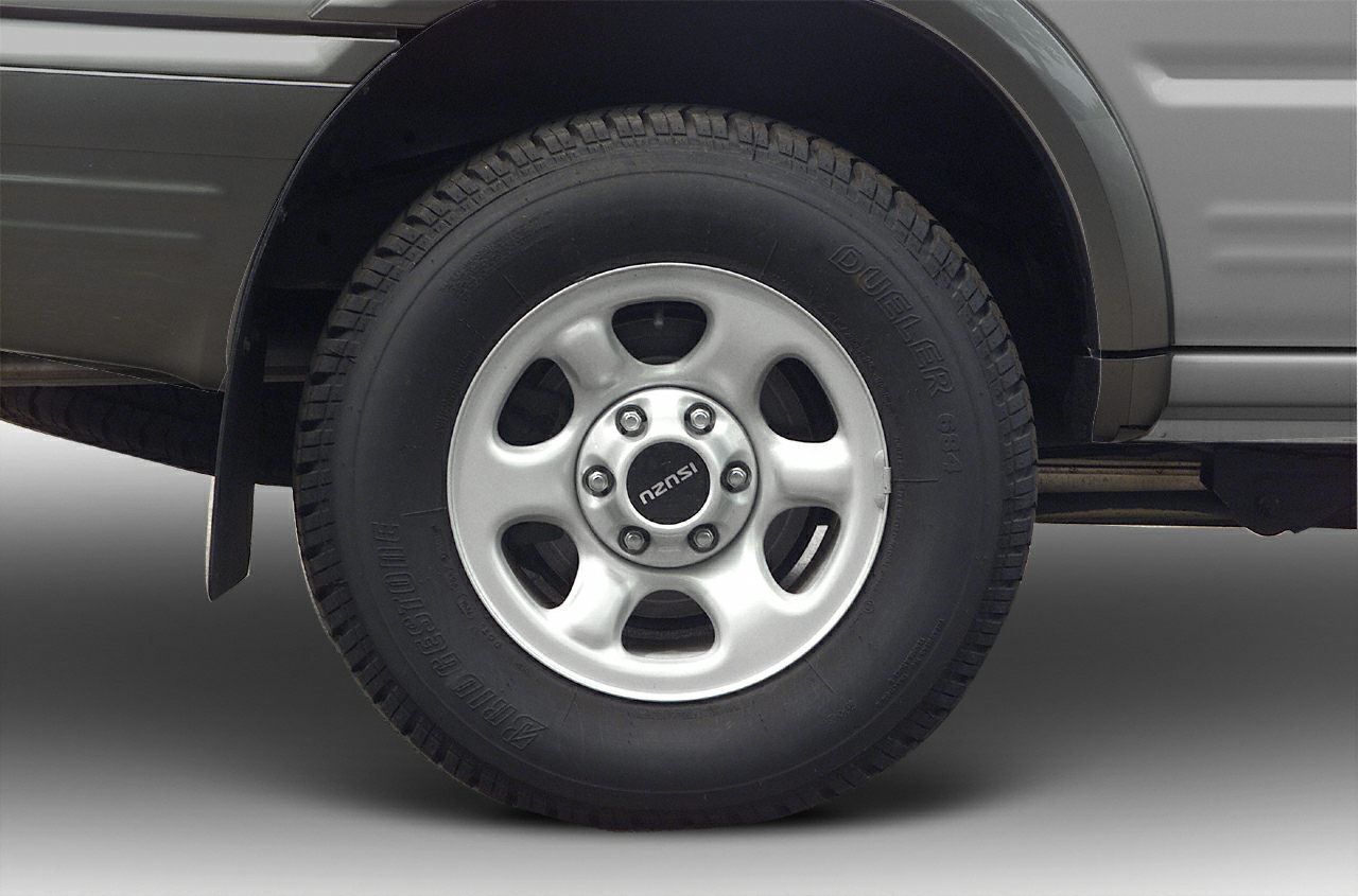 Close-up of alloy wheel and Bridgestone Dueler tire with visible tread.