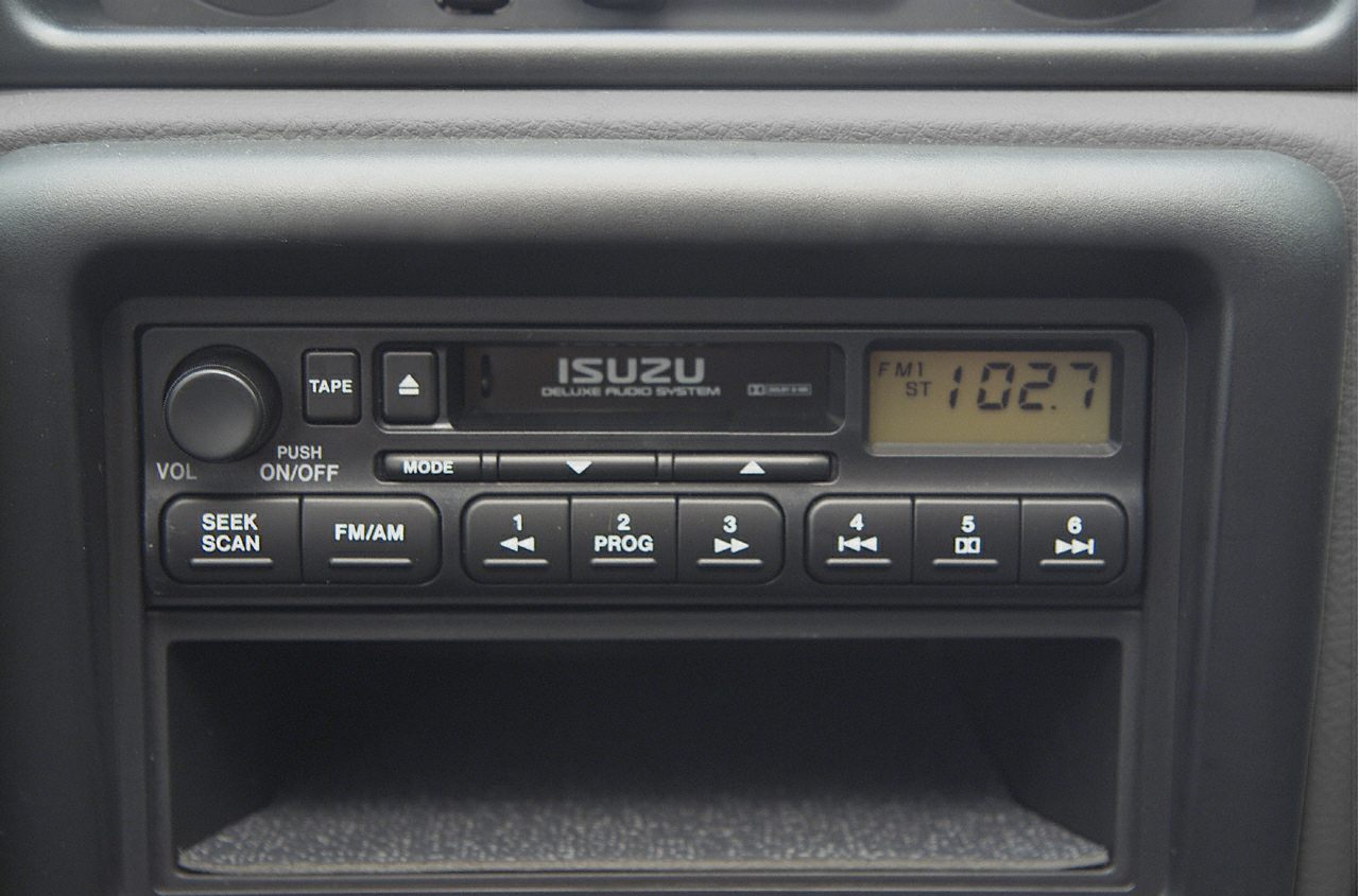 Vintage car audio system with tape player and FM/AM radio.