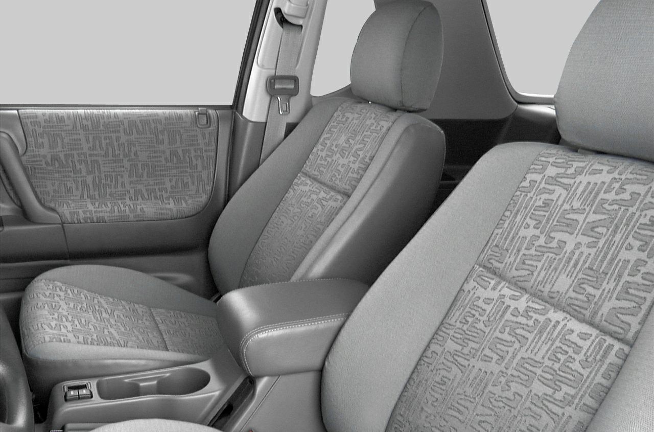 Fabric seats and door panel with patterned upholstery and armrest