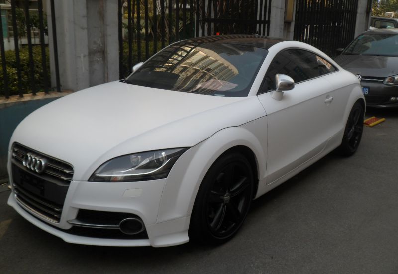 White coupe with black sporty wheels and aerodynamic design