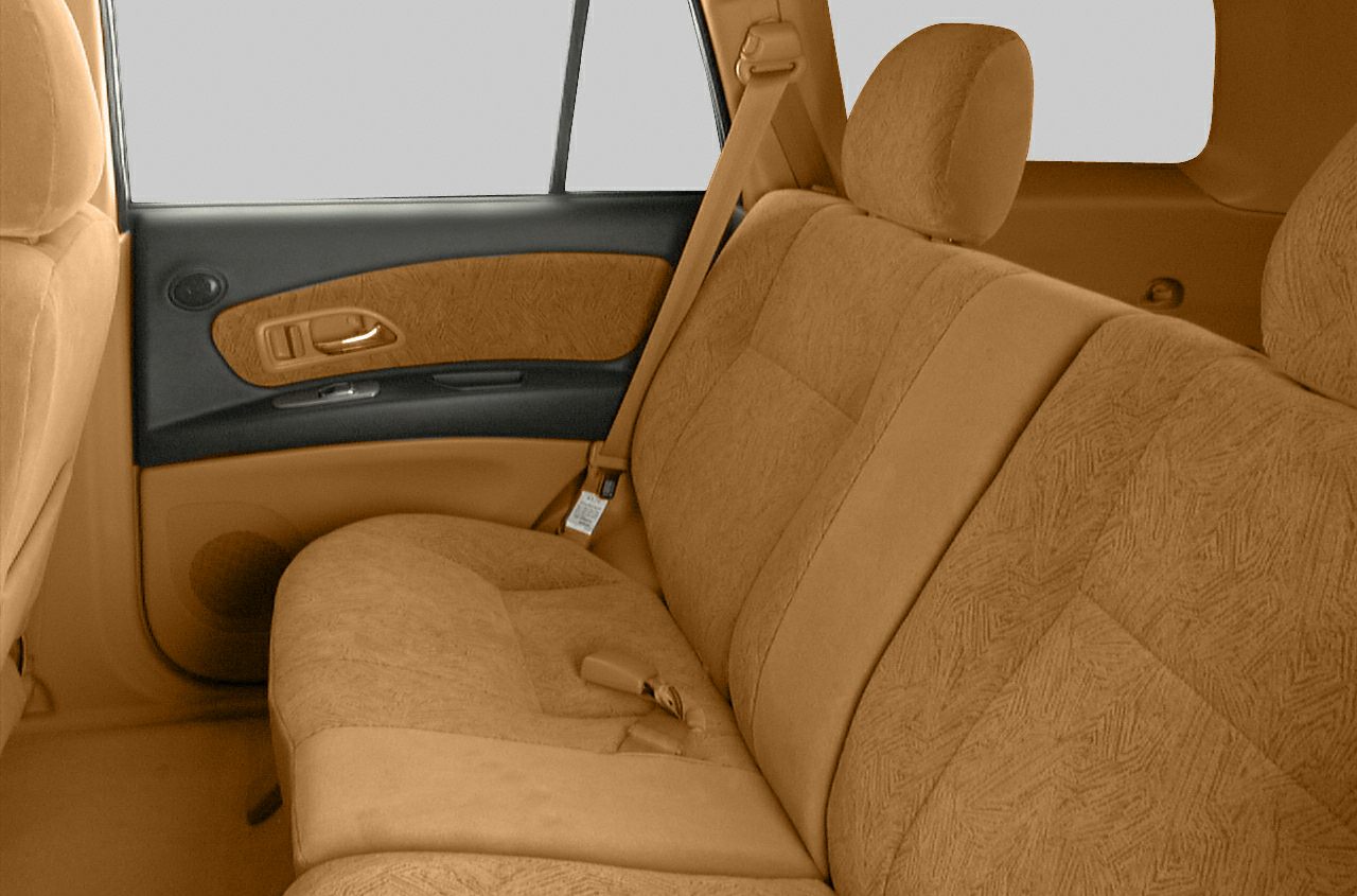 Rear seat interior with tan fabric upholstery and door panel.