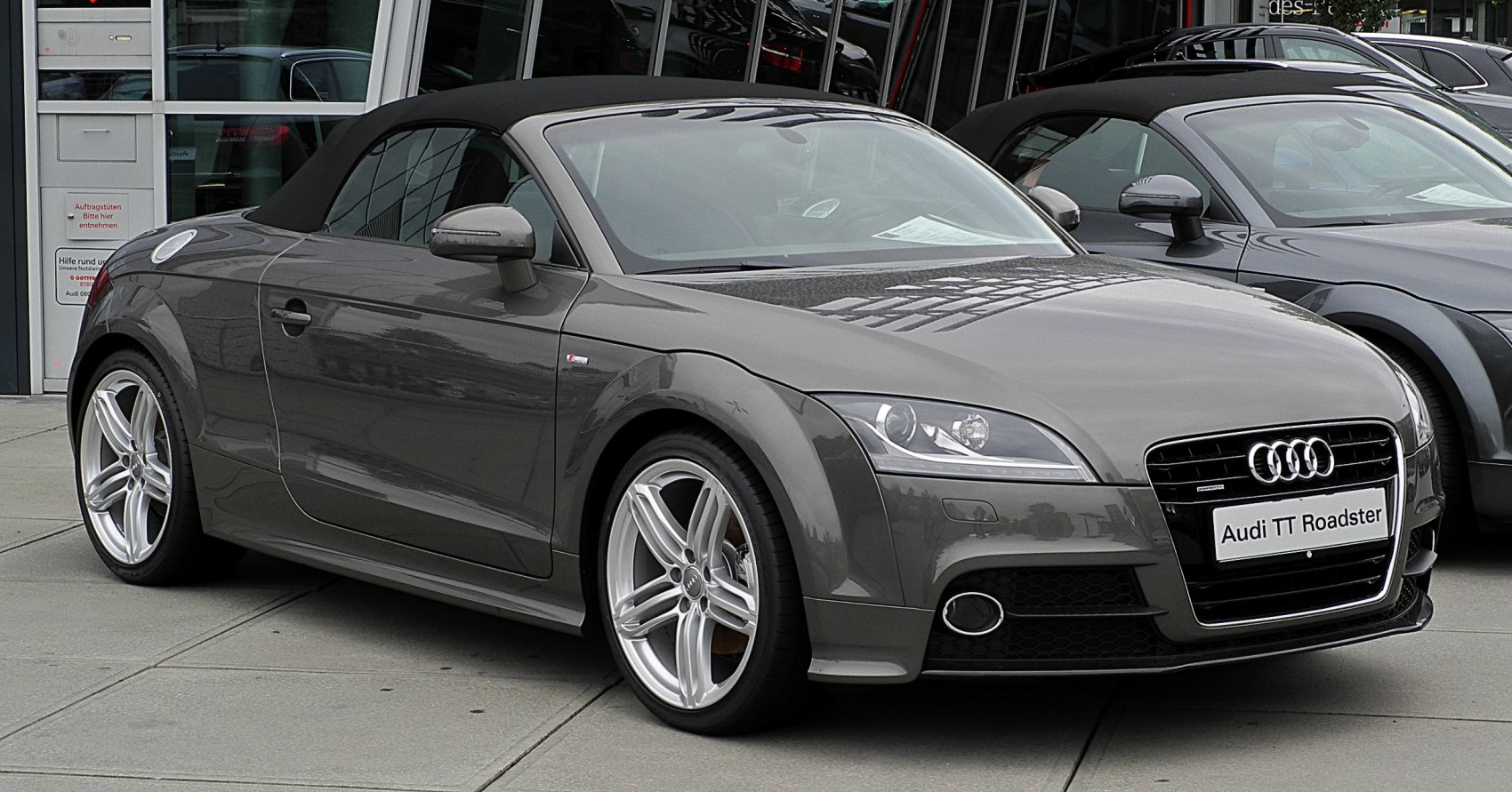 Front-side view of a soft-top convertible with alloy wheels