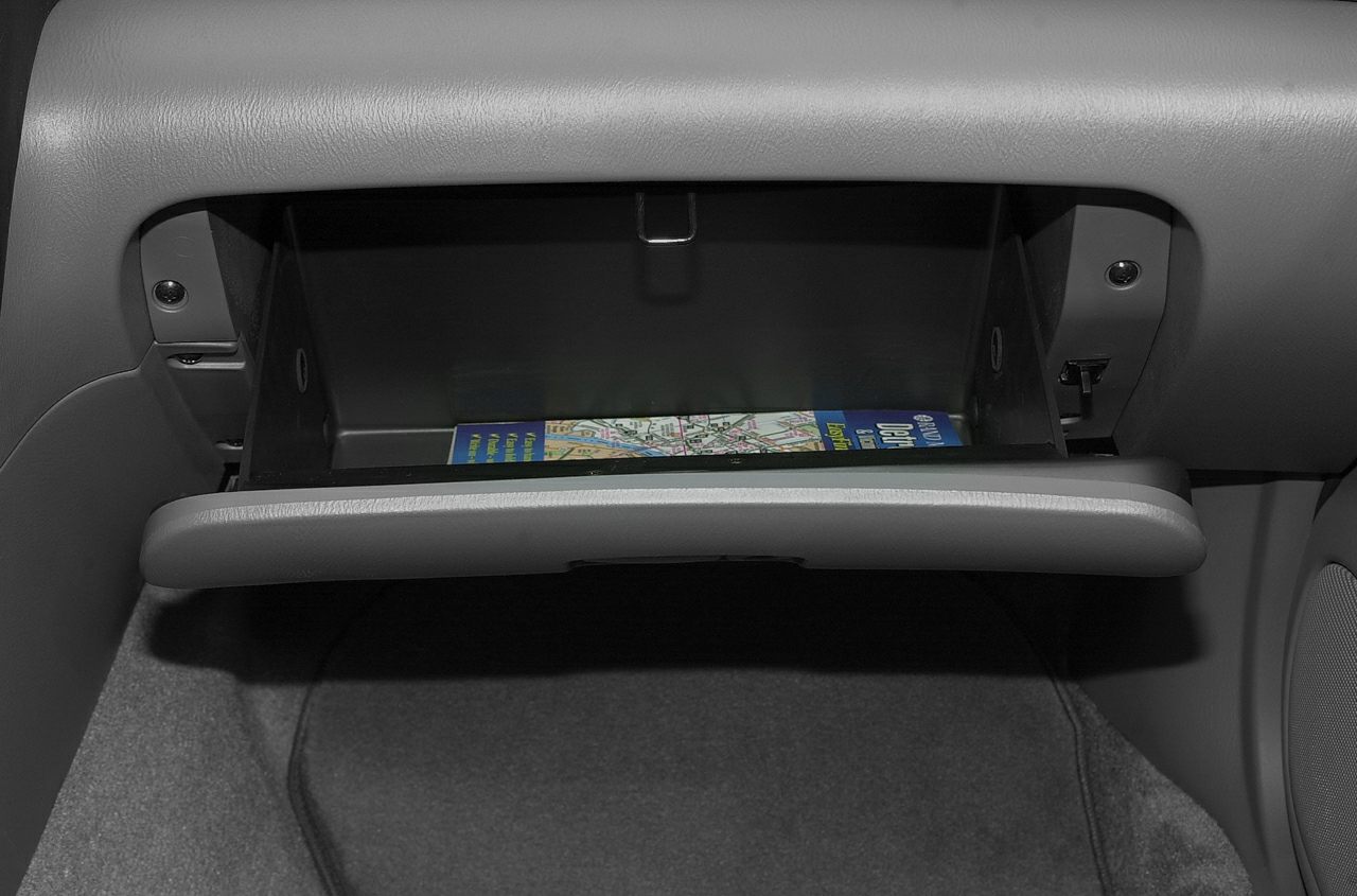 Open glove box storage compartment with visible map inside
