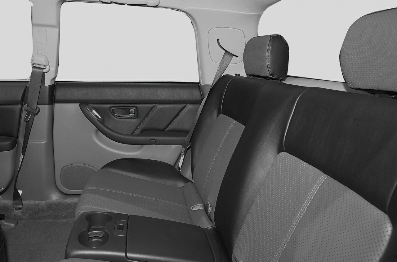 Rear seat with perforated upholstery and cup holders