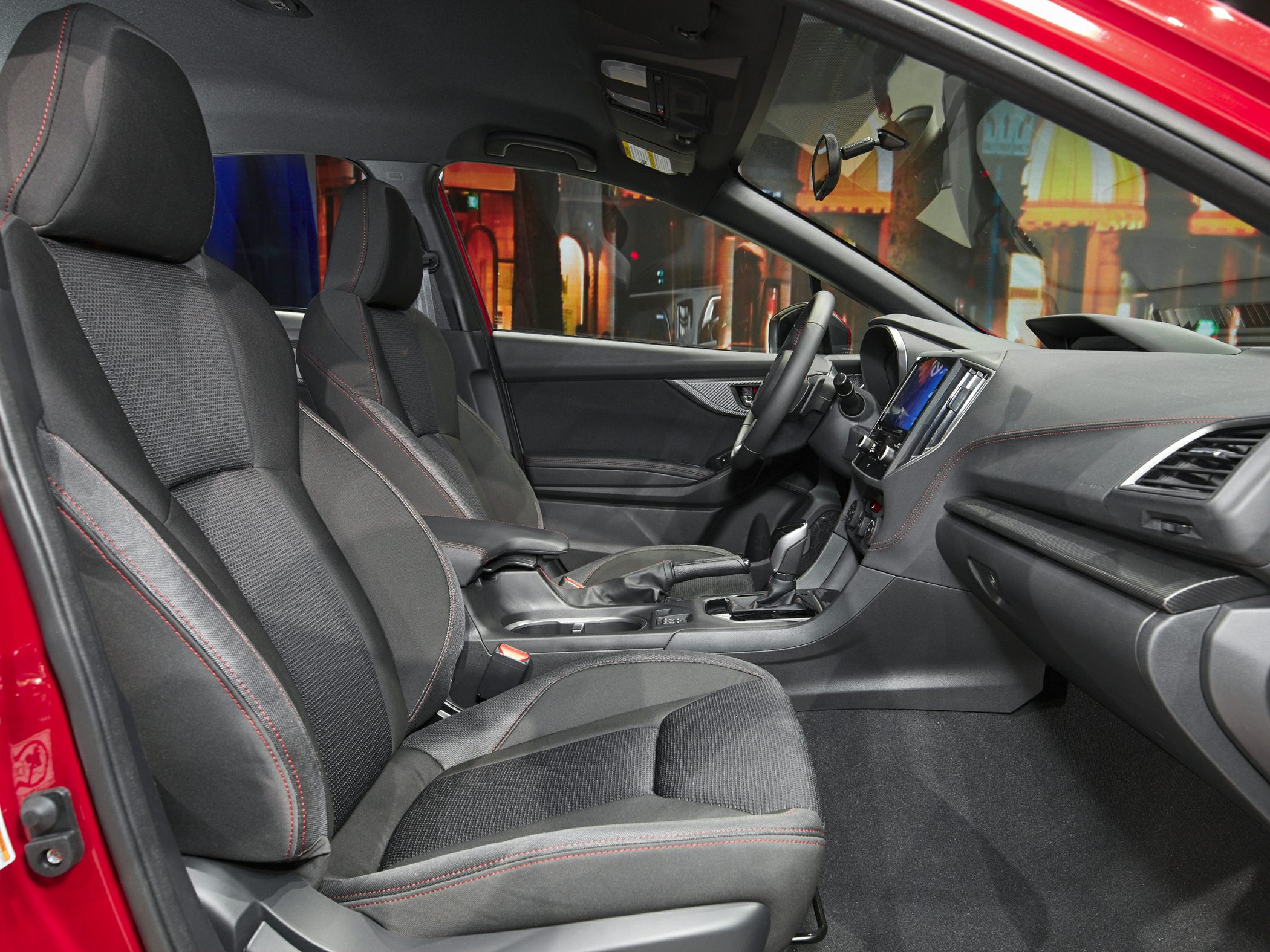 Sport seats with red stitching and center console in modern car interior