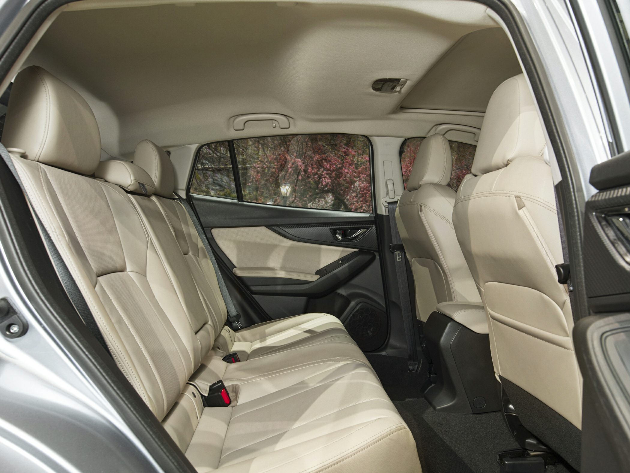 Beige leather rear seats with spacious legroom and door panel