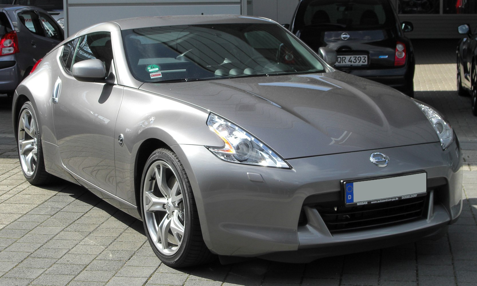Sleek silver sports coupe with aerodynamic front and alloy wheels