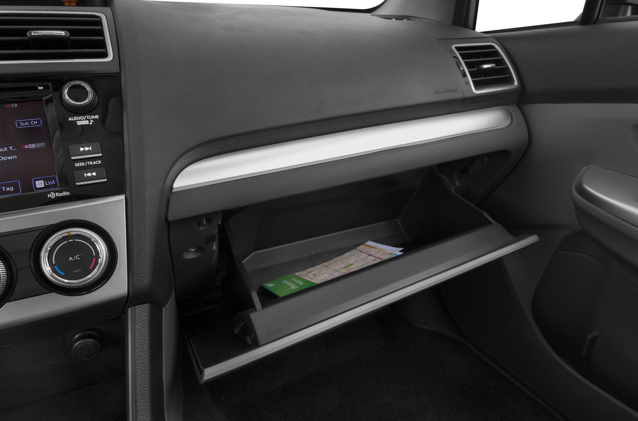 Open glove compartment and dashboard controls on passenger side interior