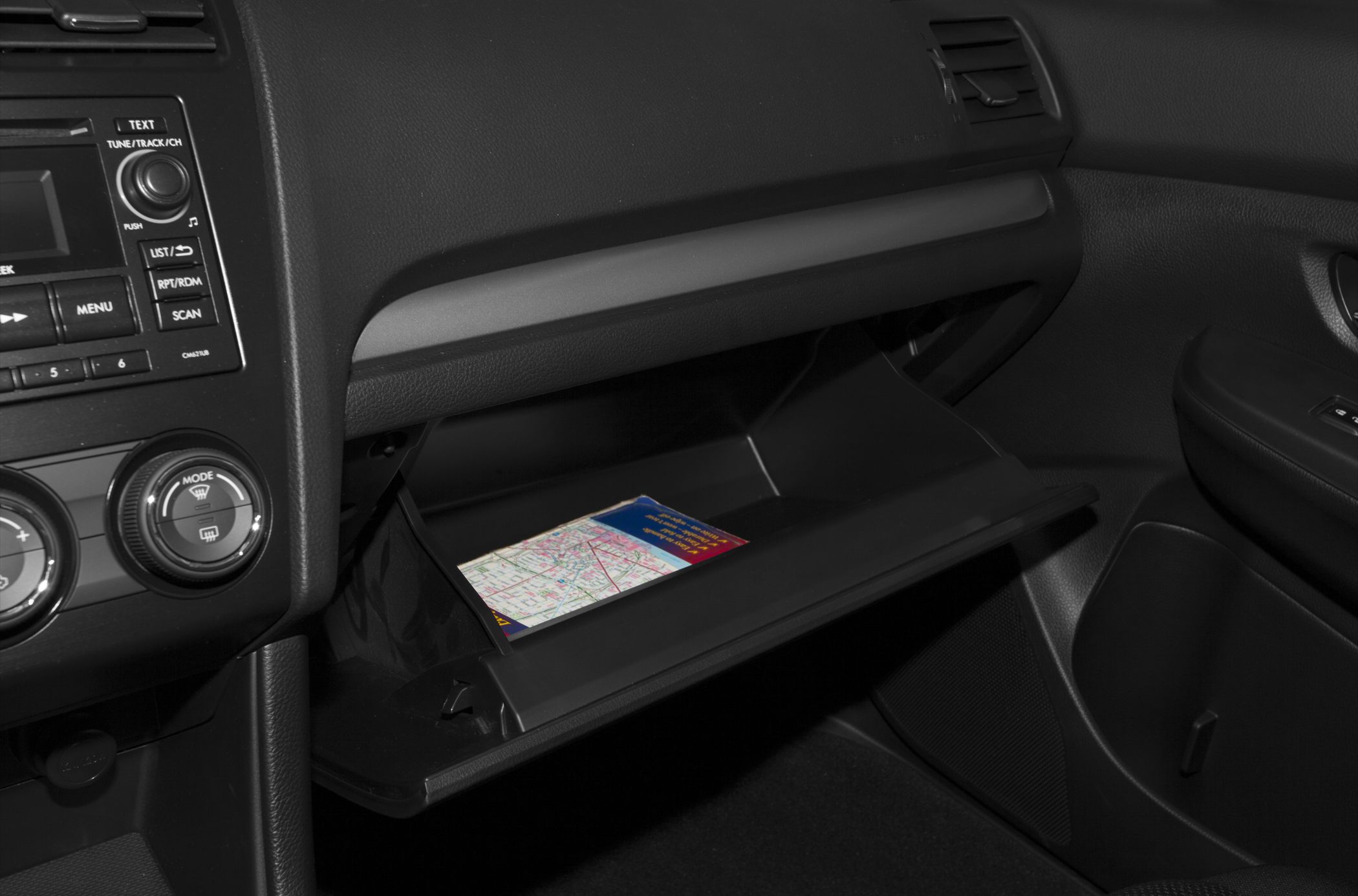 Open glove compartment with dashboard and climate controls