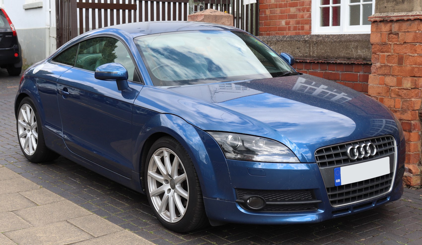 Blue coupe with LED headlights, sporty alloy wheels, and sleek grille