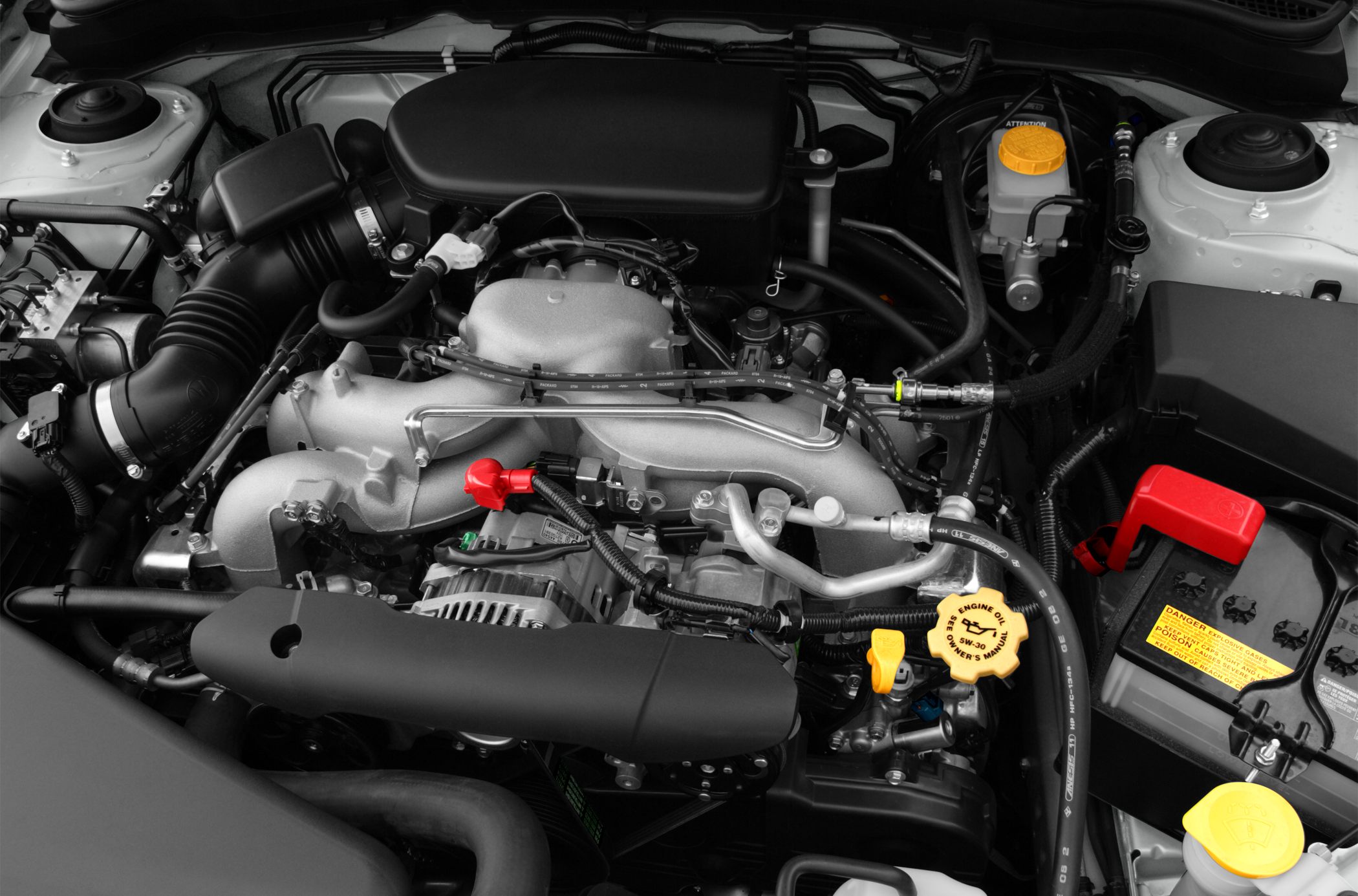 Engine bay with intake manifold, battery, and fluid caps