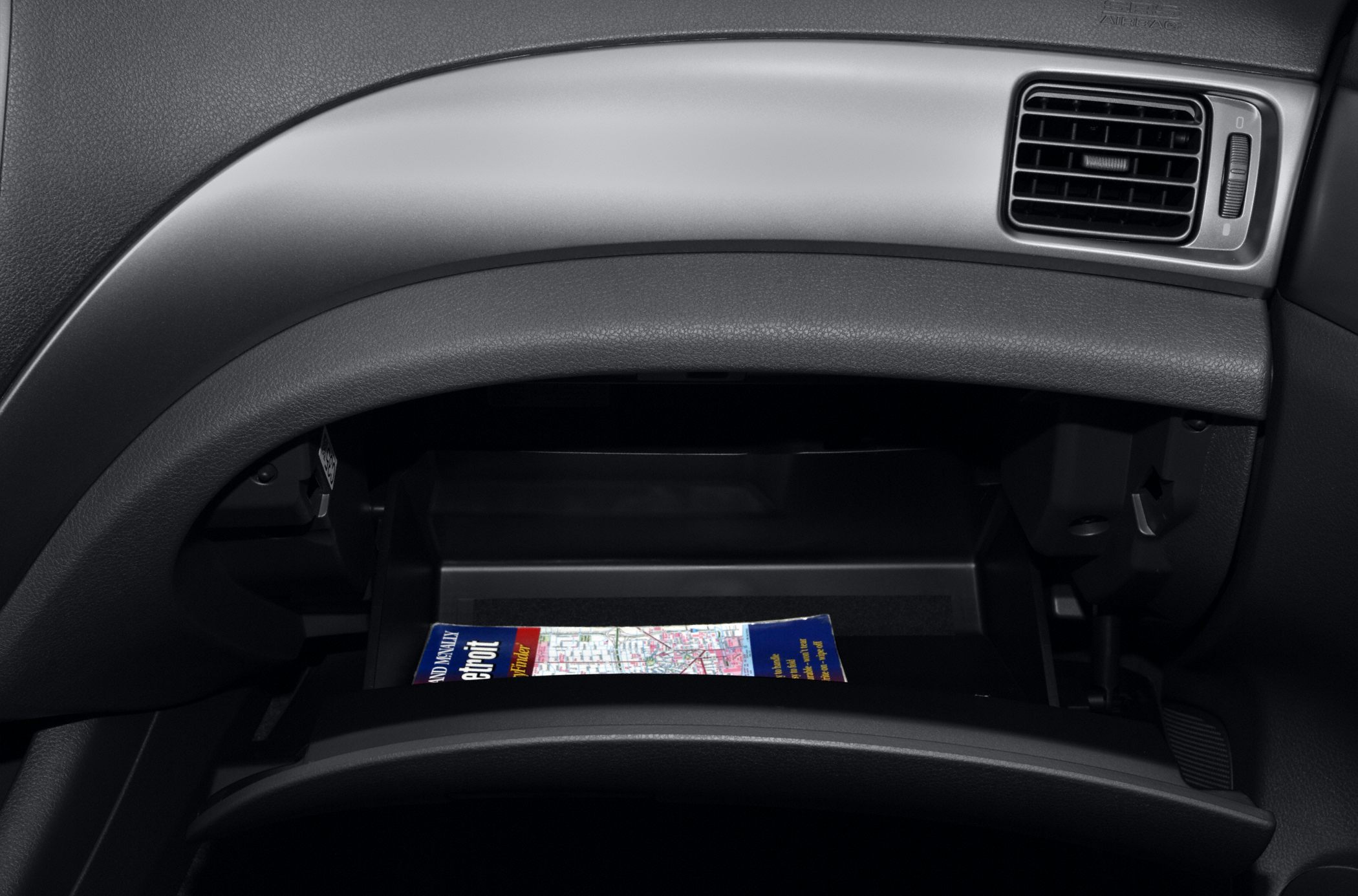 Open glove box compartment with dashboard air vent