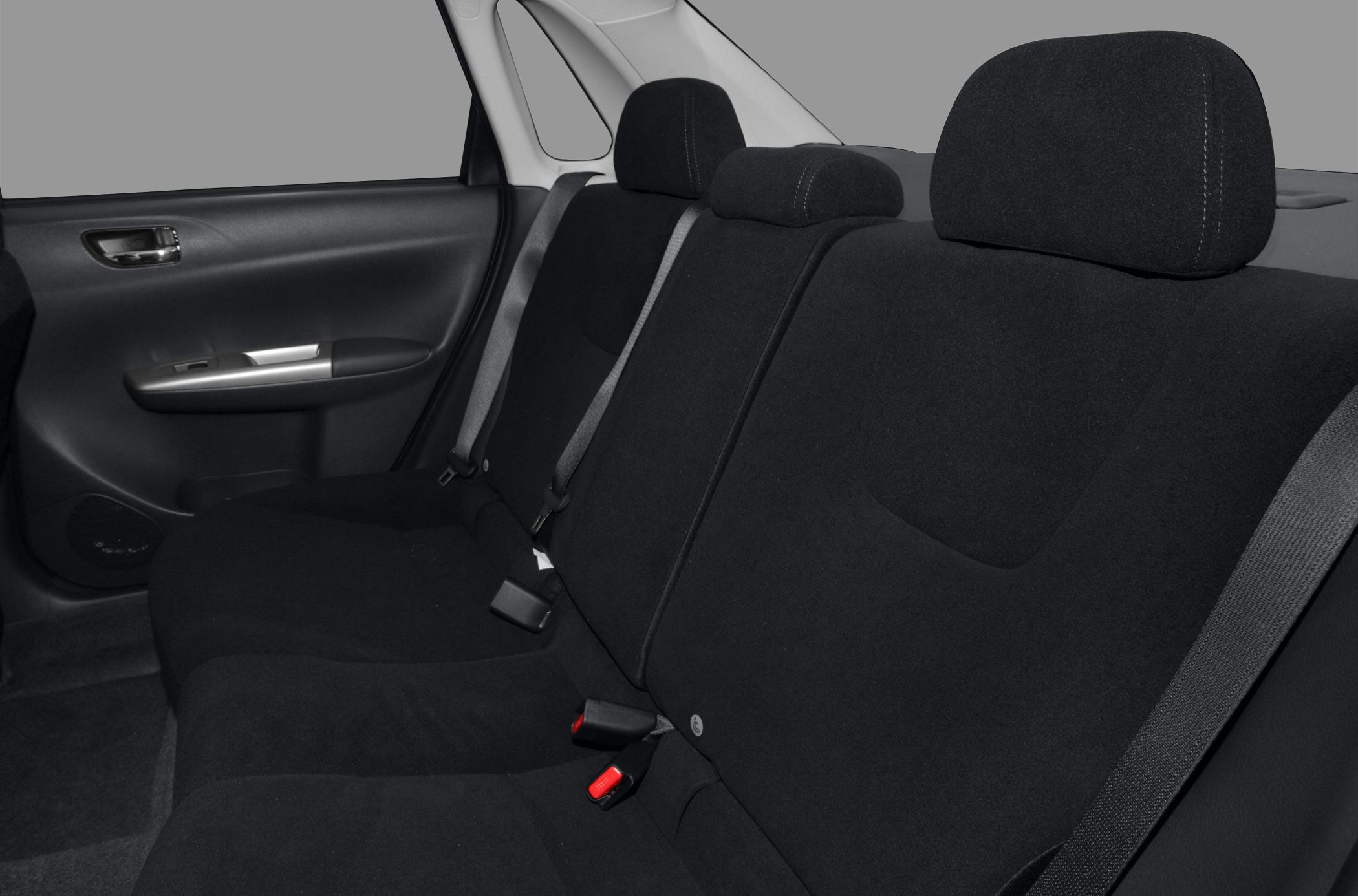 Black fabric rear seats with seatbelts and headrests inside sedan