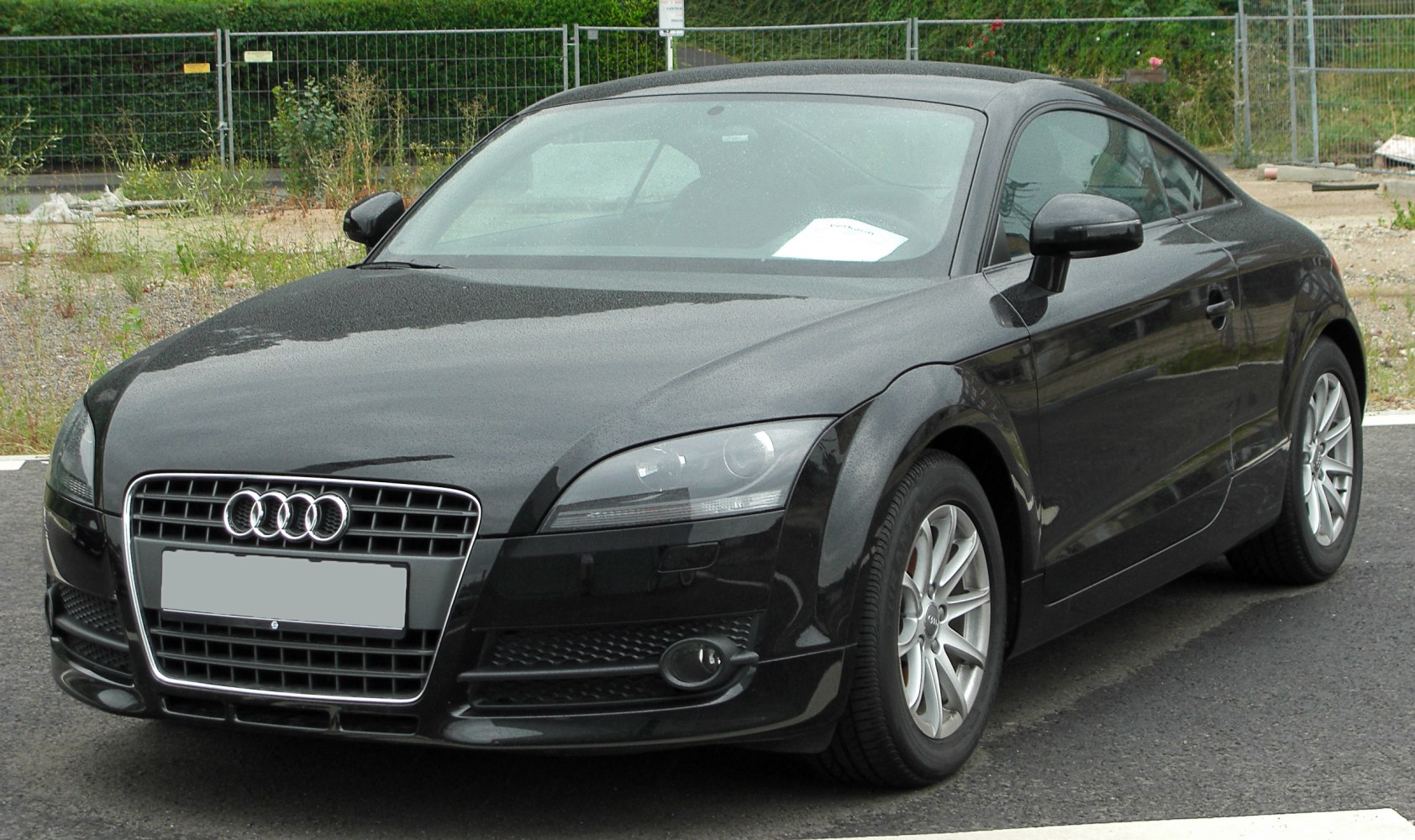 Sleek front view with distinctive grille and sporty headlights