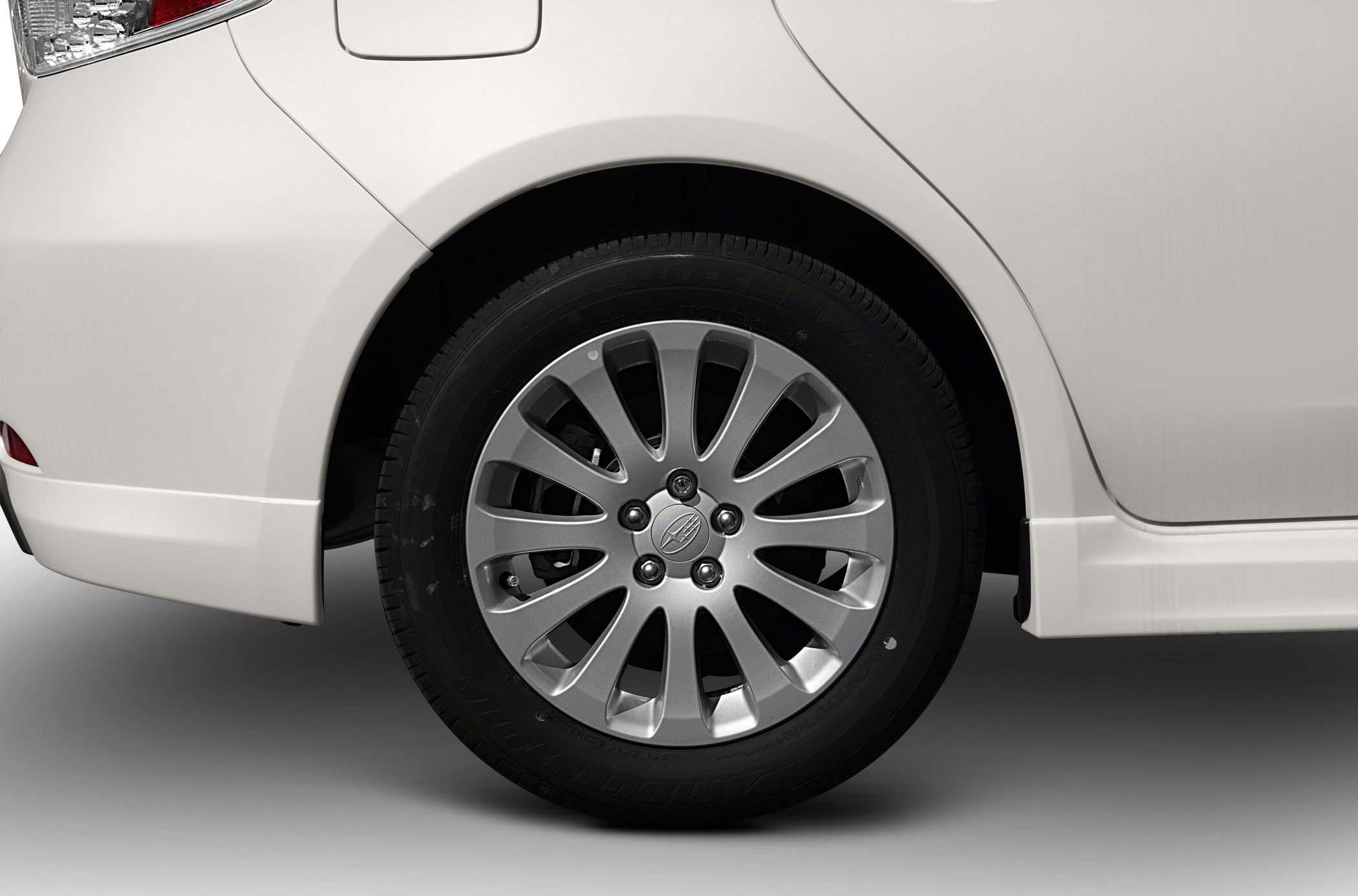 Close-up of rear wheel with multi-spoke alloy rim and rear quarter panel.