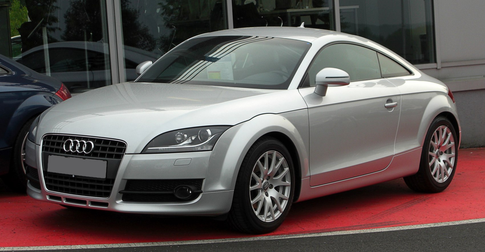 Silver sporty coupe with rounded profile and alloy wheels