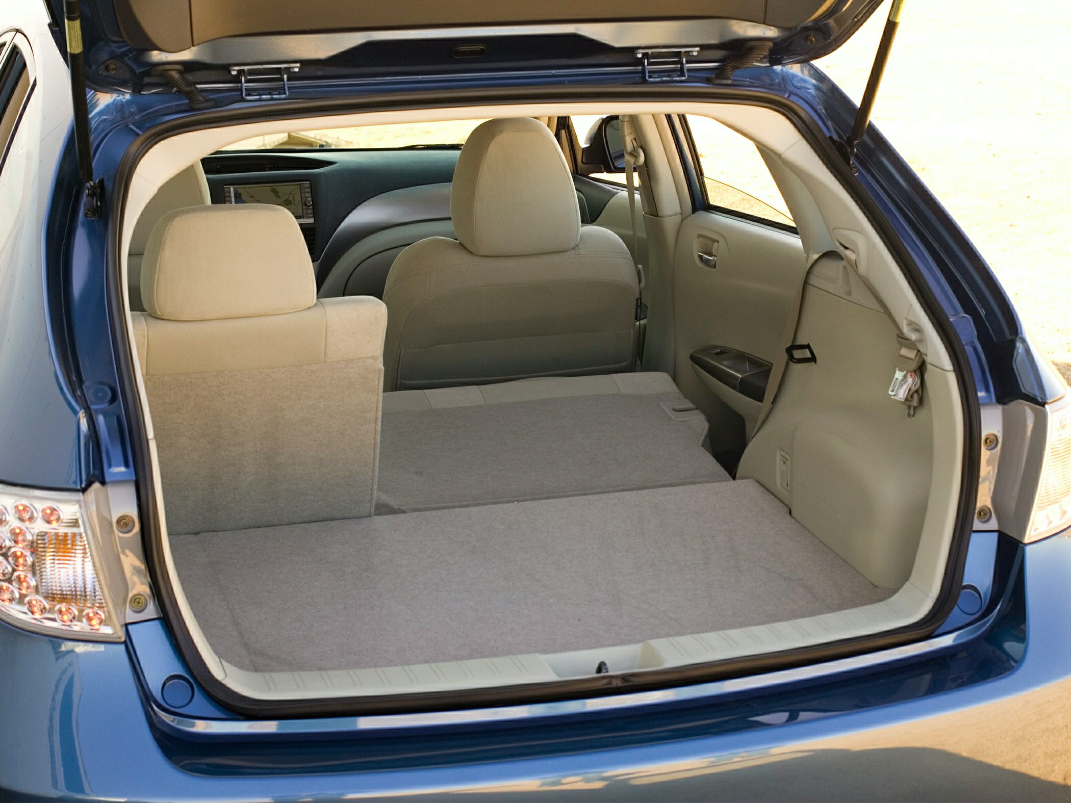 Folded rear seats creating a spacious flat cargo area in hatchback interior