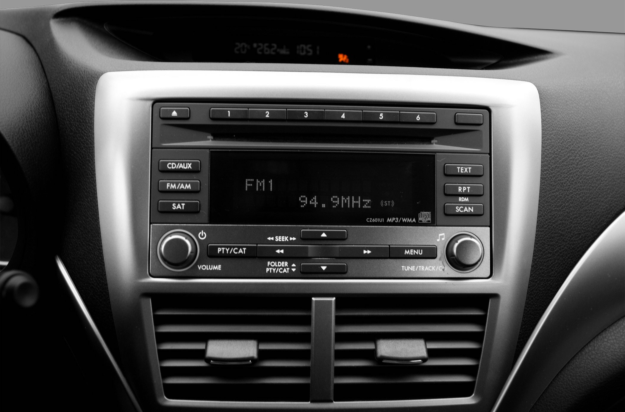 Car stereo and air vent console with FM1 radio, control buttons, and display screen