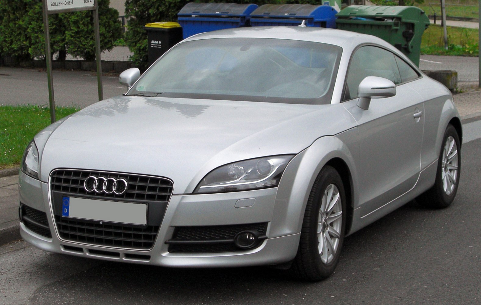 Front view of a sports coupe with distinctive headlights and alloy wheels