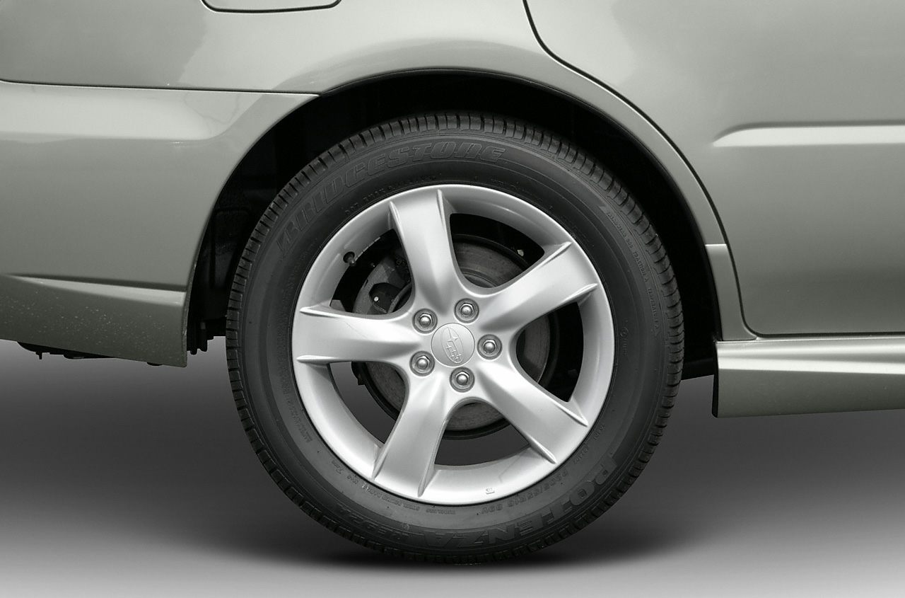 Five-spoke alloy wheel and rear fender close-up with Bridgestone tire