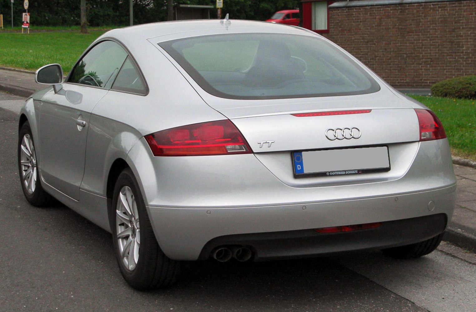 Rear view showing distinctive taillights and dual exhausts