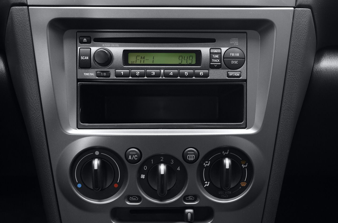 Dashboard center console with radio and climate control knobs