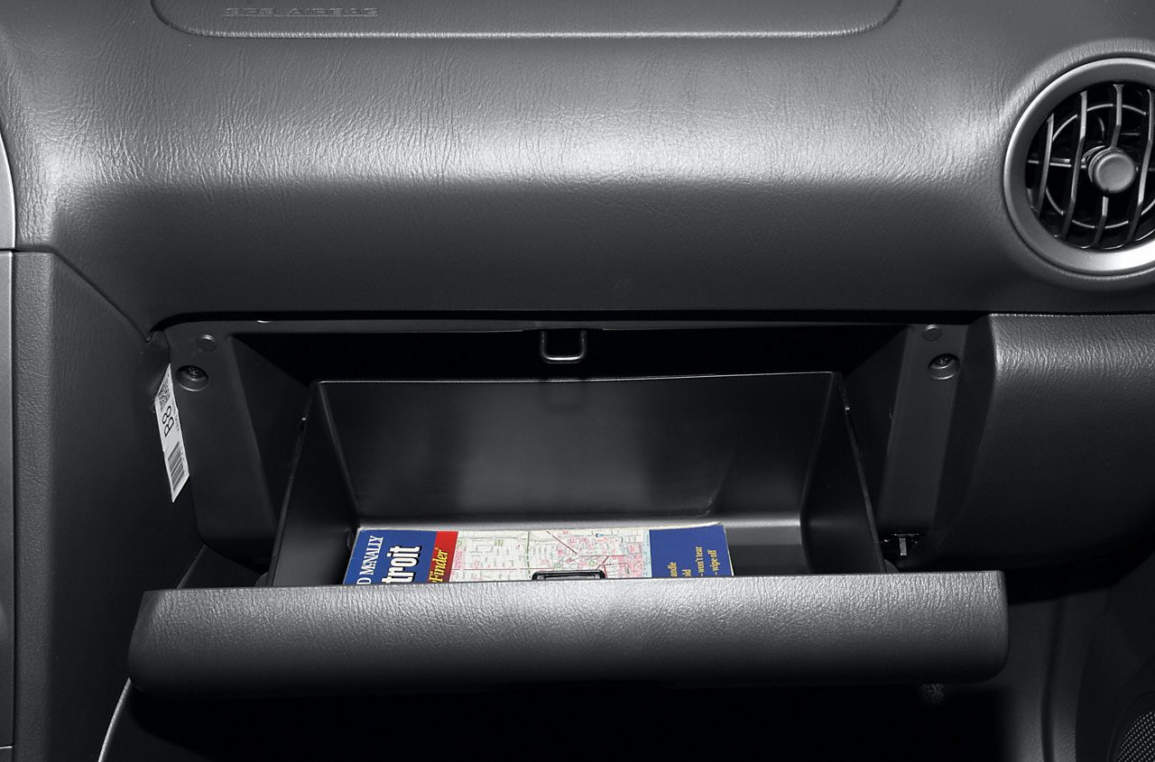 Open glove box with a map inside in a car interior