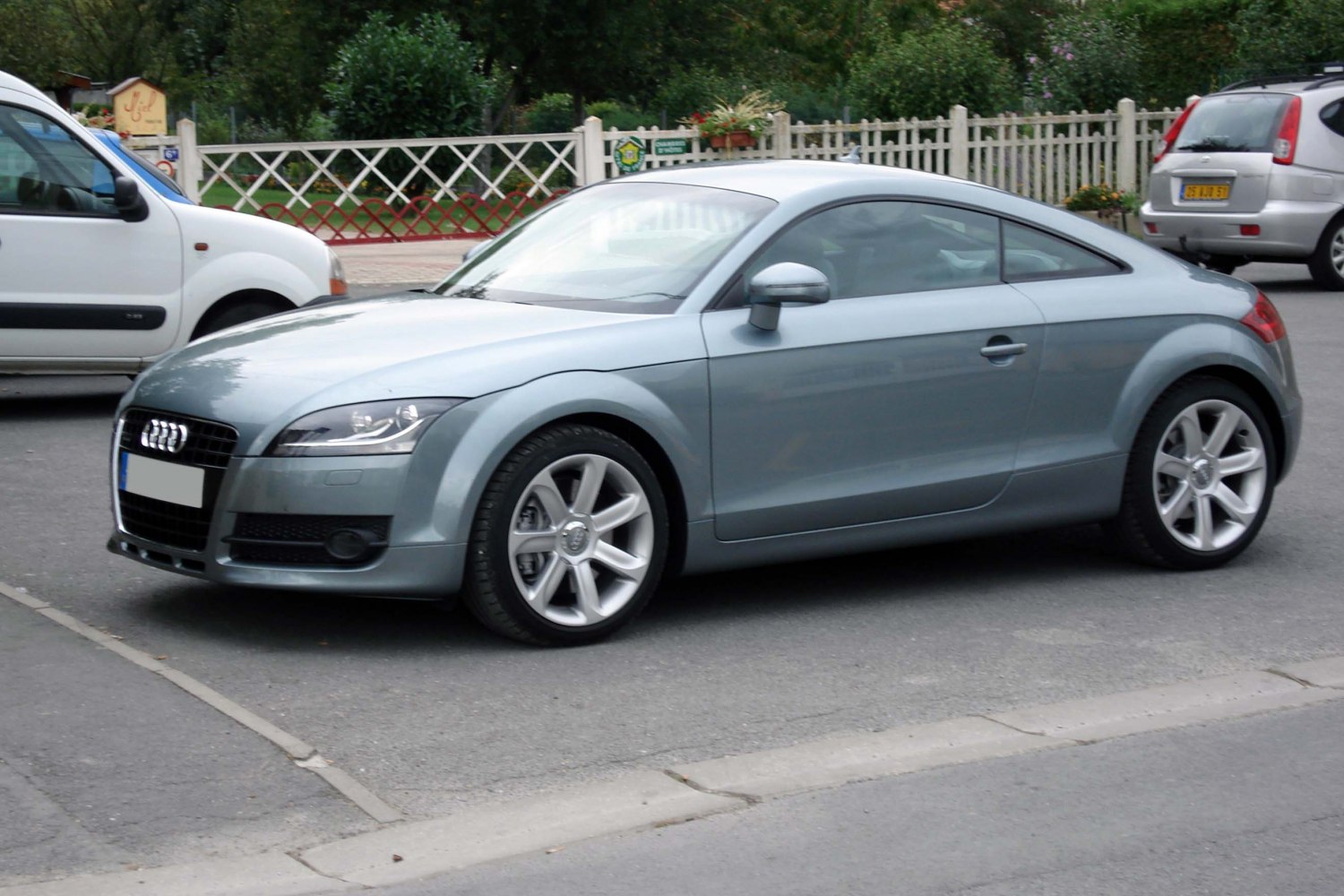 Side profile of sleek coupe with alloy wheels and smooth curves