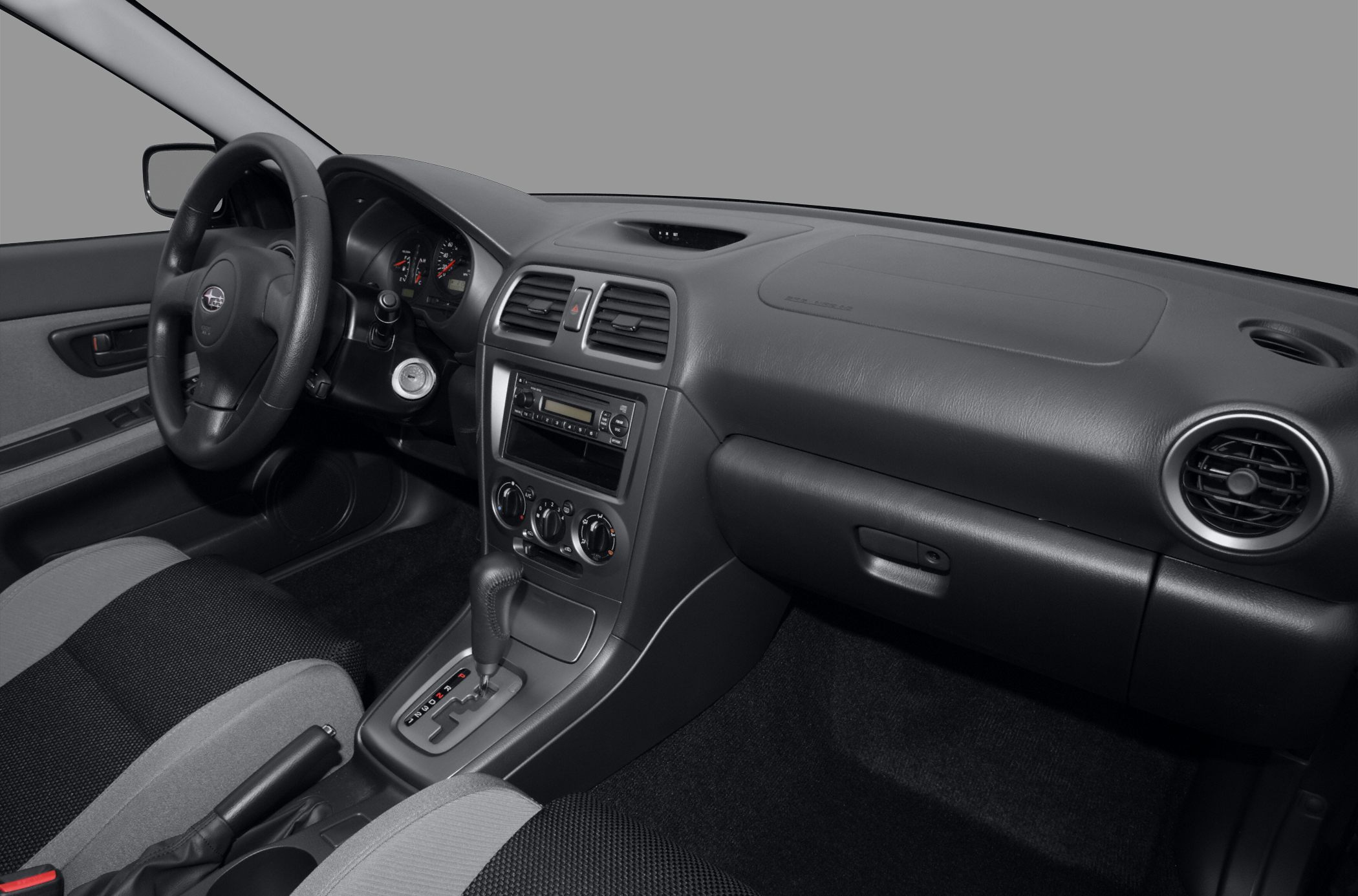 Vehicle interior with dashboard, steering wheel, center console, and automatic gear shift