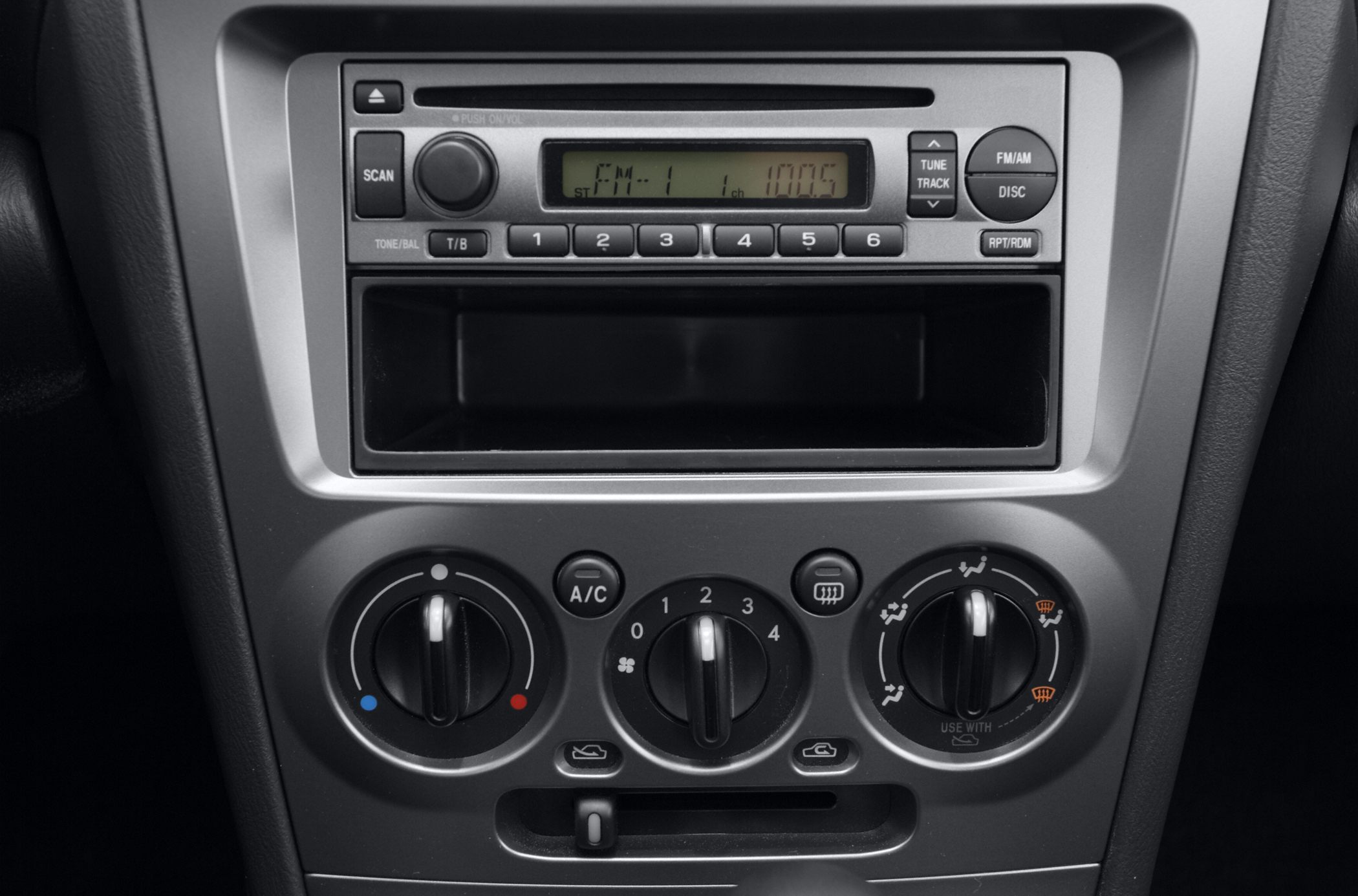 Car stereo and climate control panel with knobs and buttons