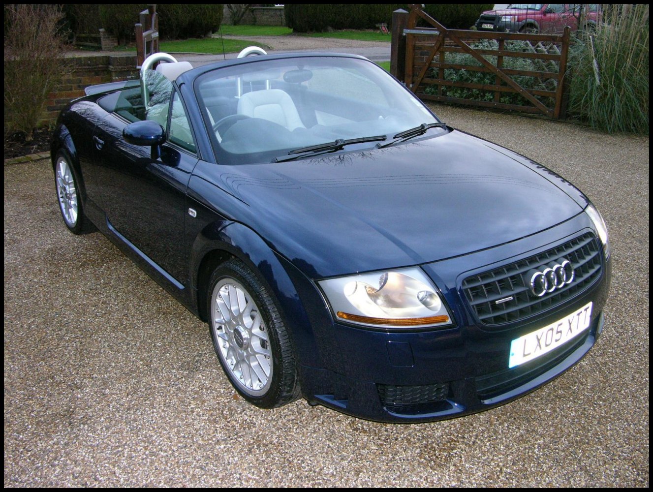 Convertible with distinct headlights and grille at front angle