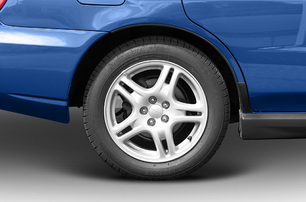 Close-up of a silver alloy wheel with Bridgestone Potenza RE92 tire