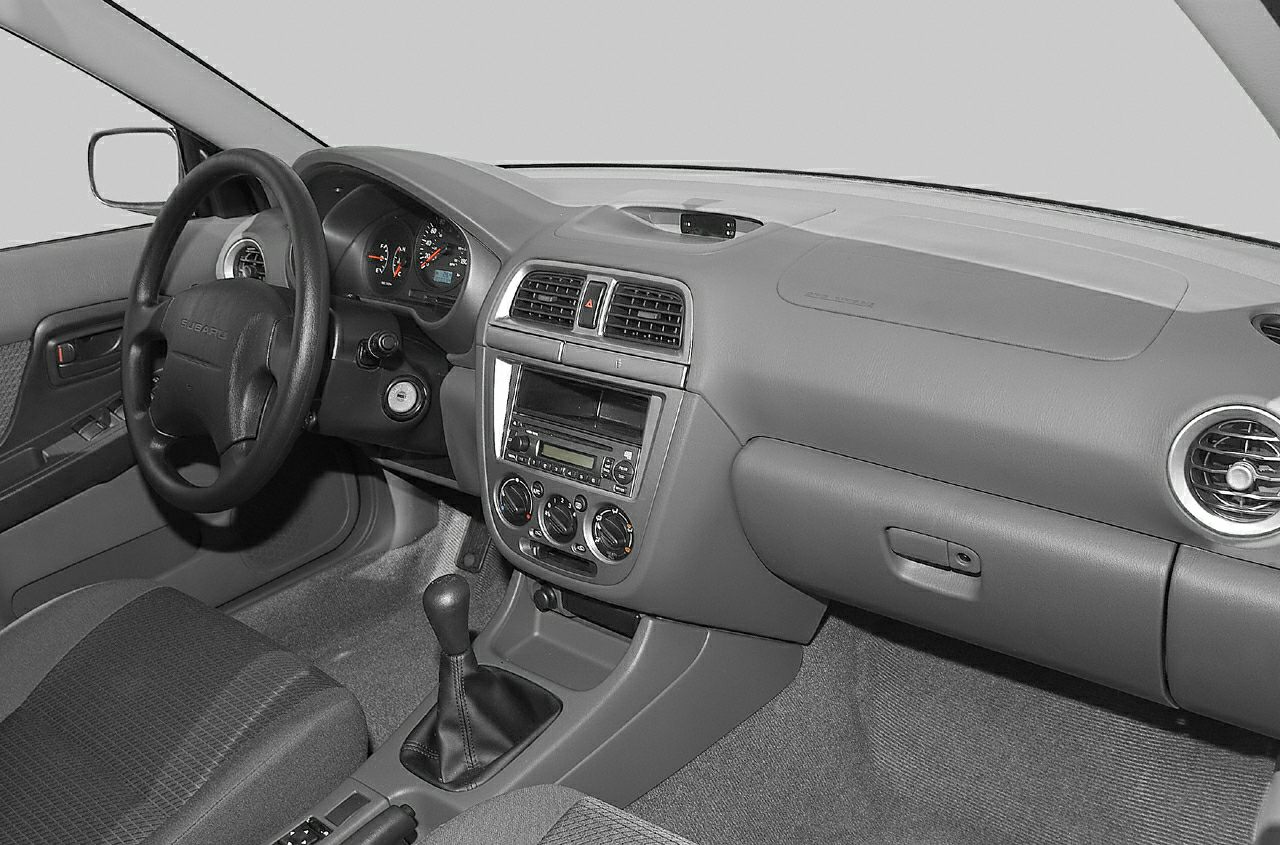 Dashboard and manual transmission interior of mid-2000s station wagon