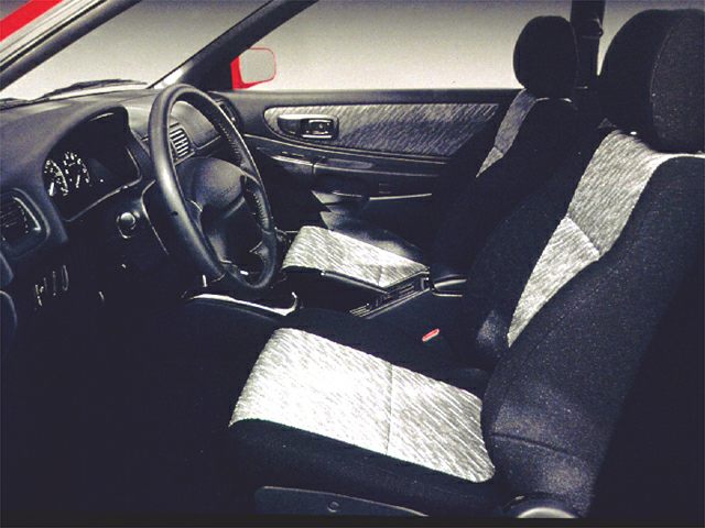 Fabric front seats and dashboard of early 1990s compact station wagon interior