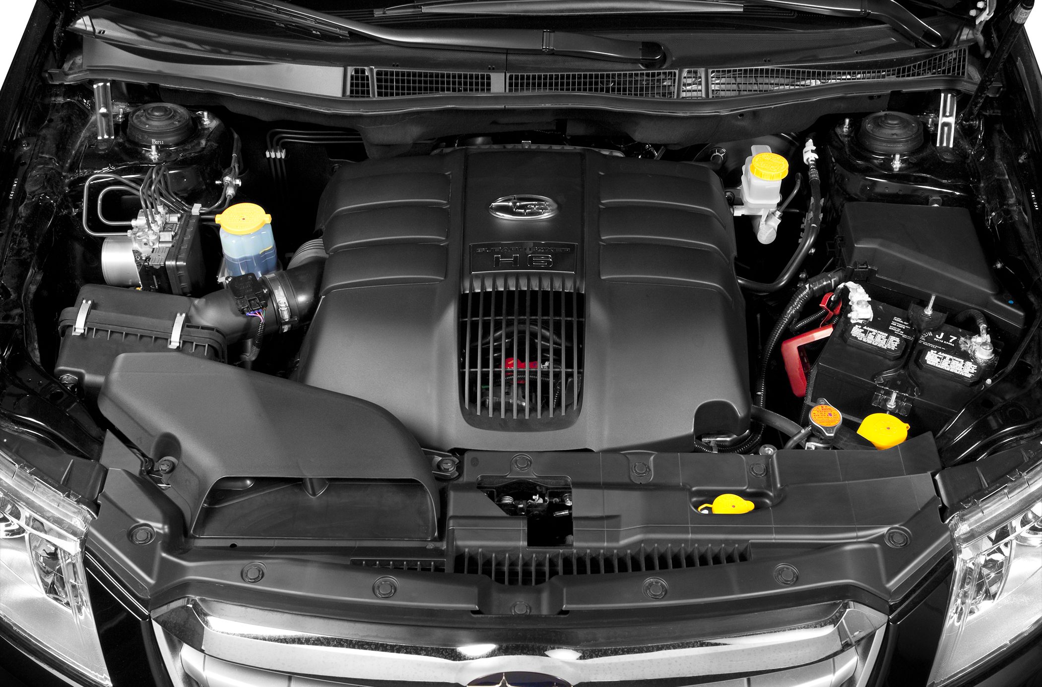 Close-up of a H6 engine bay with visible components and engine cover