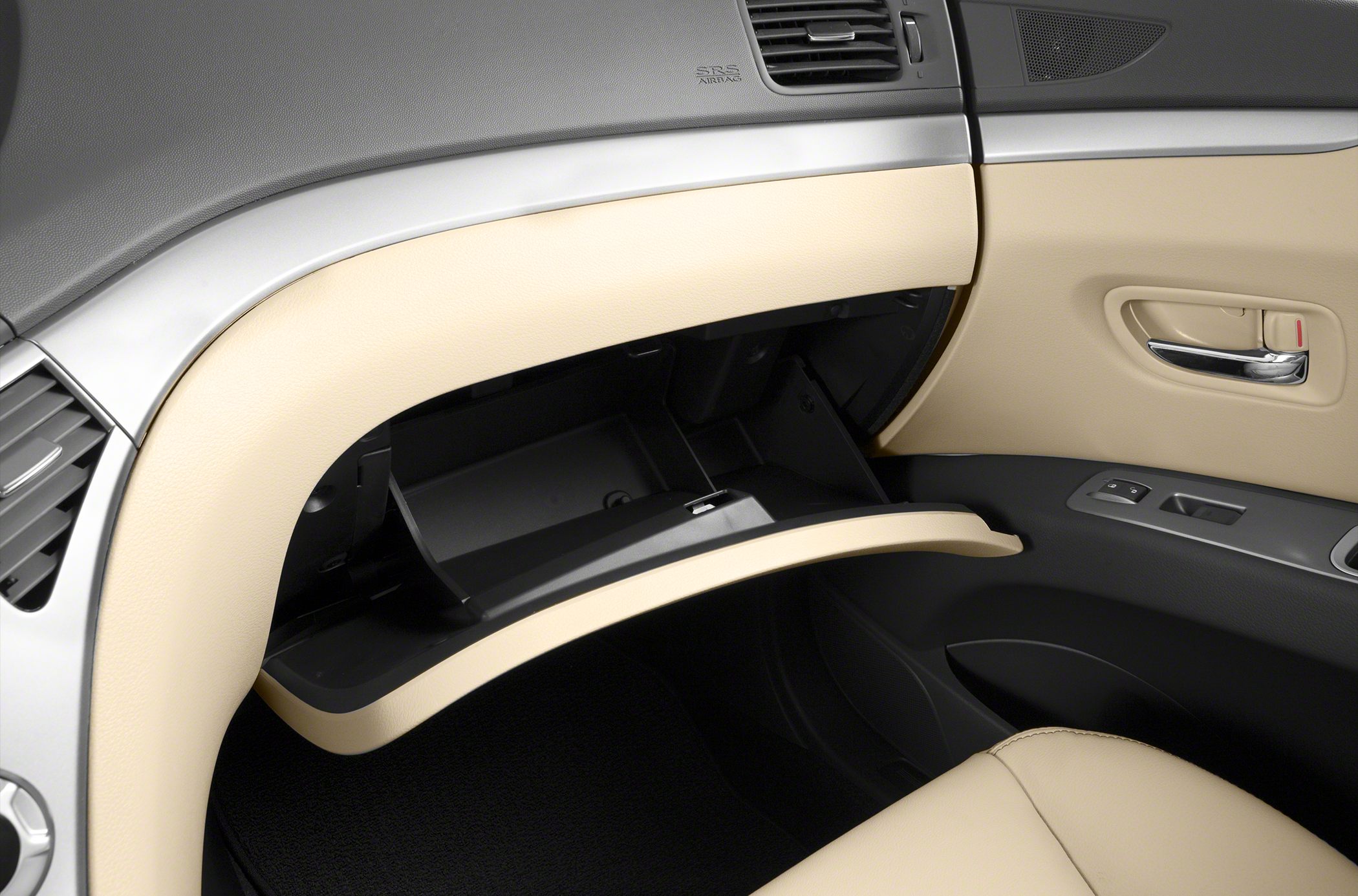 Open glove compartment and beige interior door panel with controls
