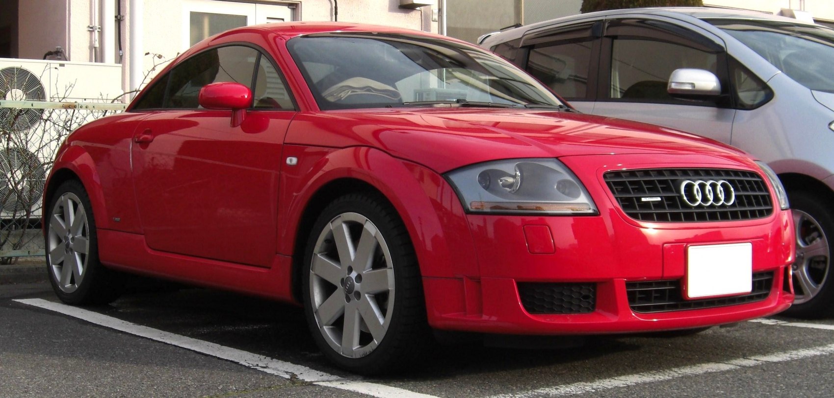 Red coupe with alloy wheels and sleek front design