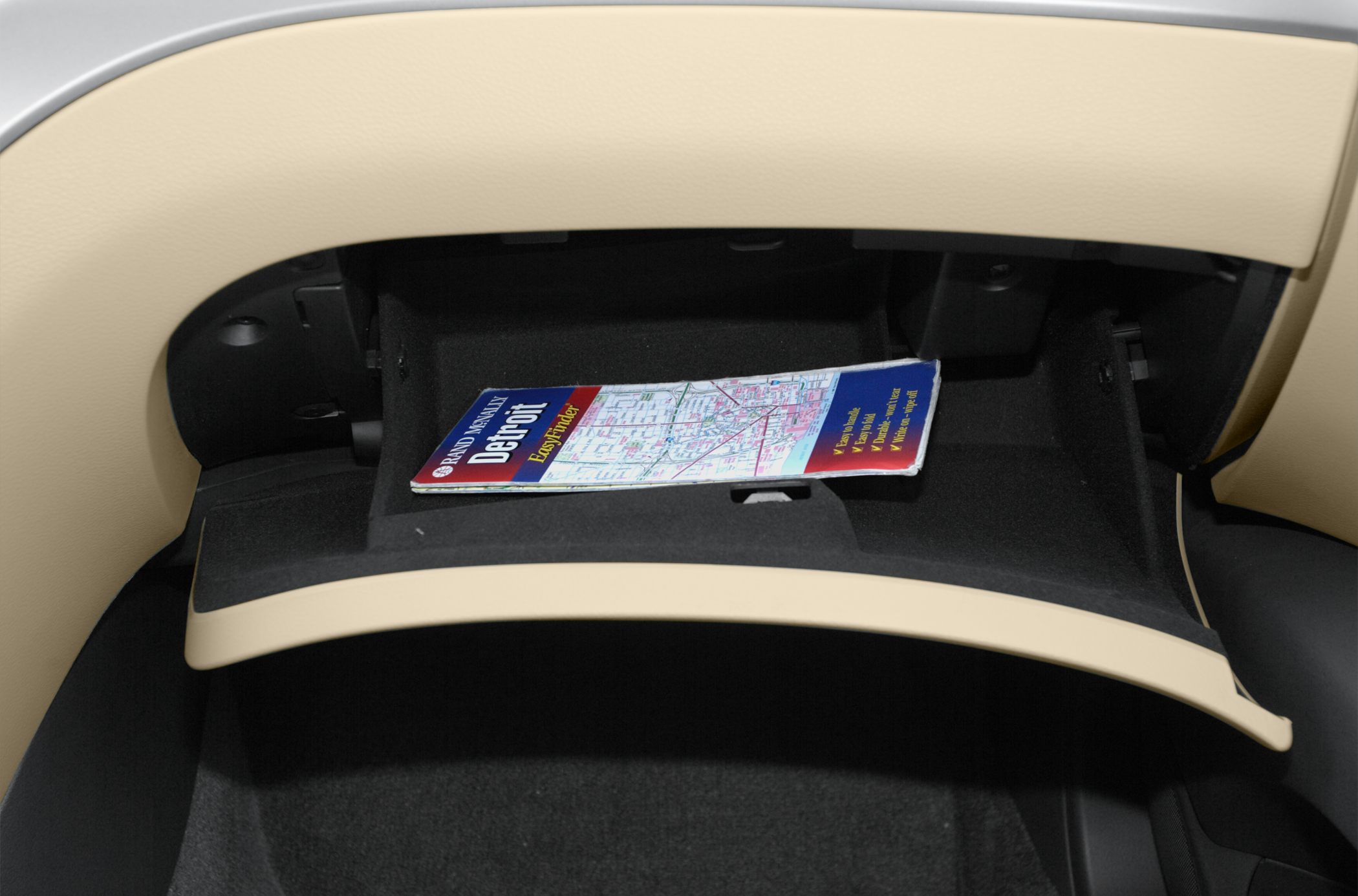 Open glove box with map inside beige interior